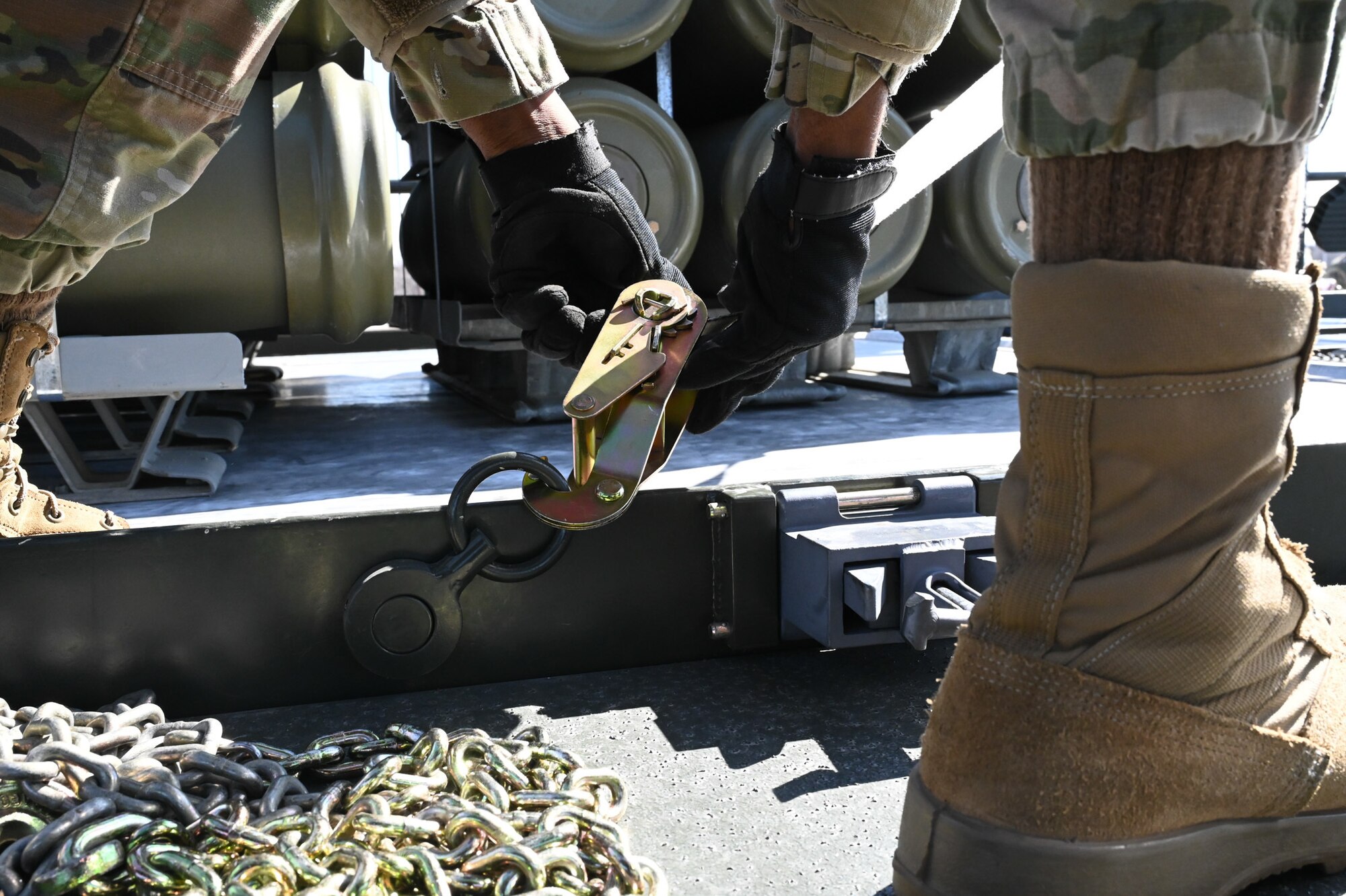 airman tying down munitions