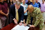 The Director of U.S. Army Installation Management Command-Pacific, Craig Deatrick, and Command Sergeant Major Jon Y. Williams, signed the IMCOM Leadership Pledge with several members of the IMCOM-Pacific team in attendance on Tuesday, Feb. 28, 2023 at IMCOM-Pacific headquarters.
