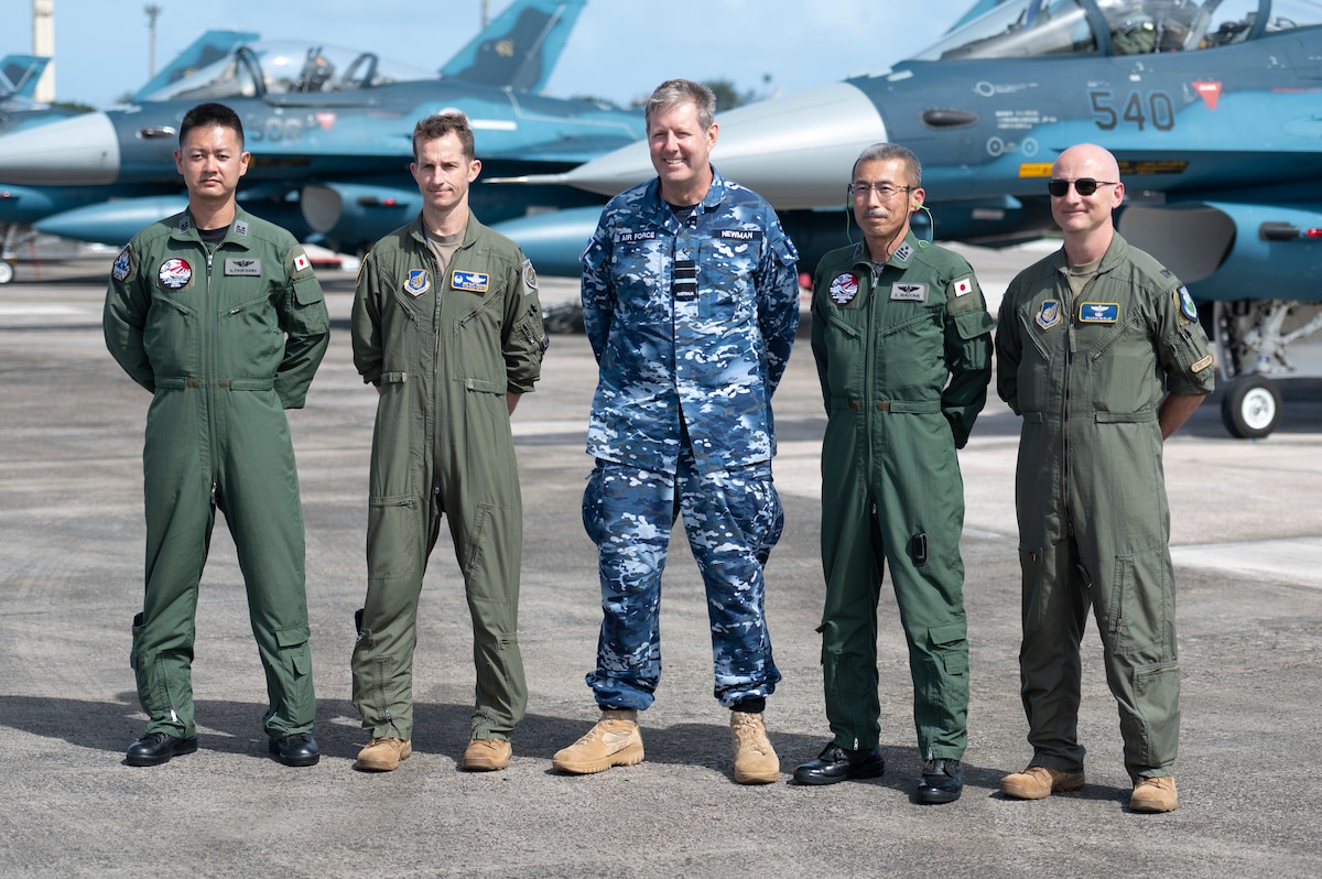 Photo of leaders from militaries across the pacific posing on a flightline.