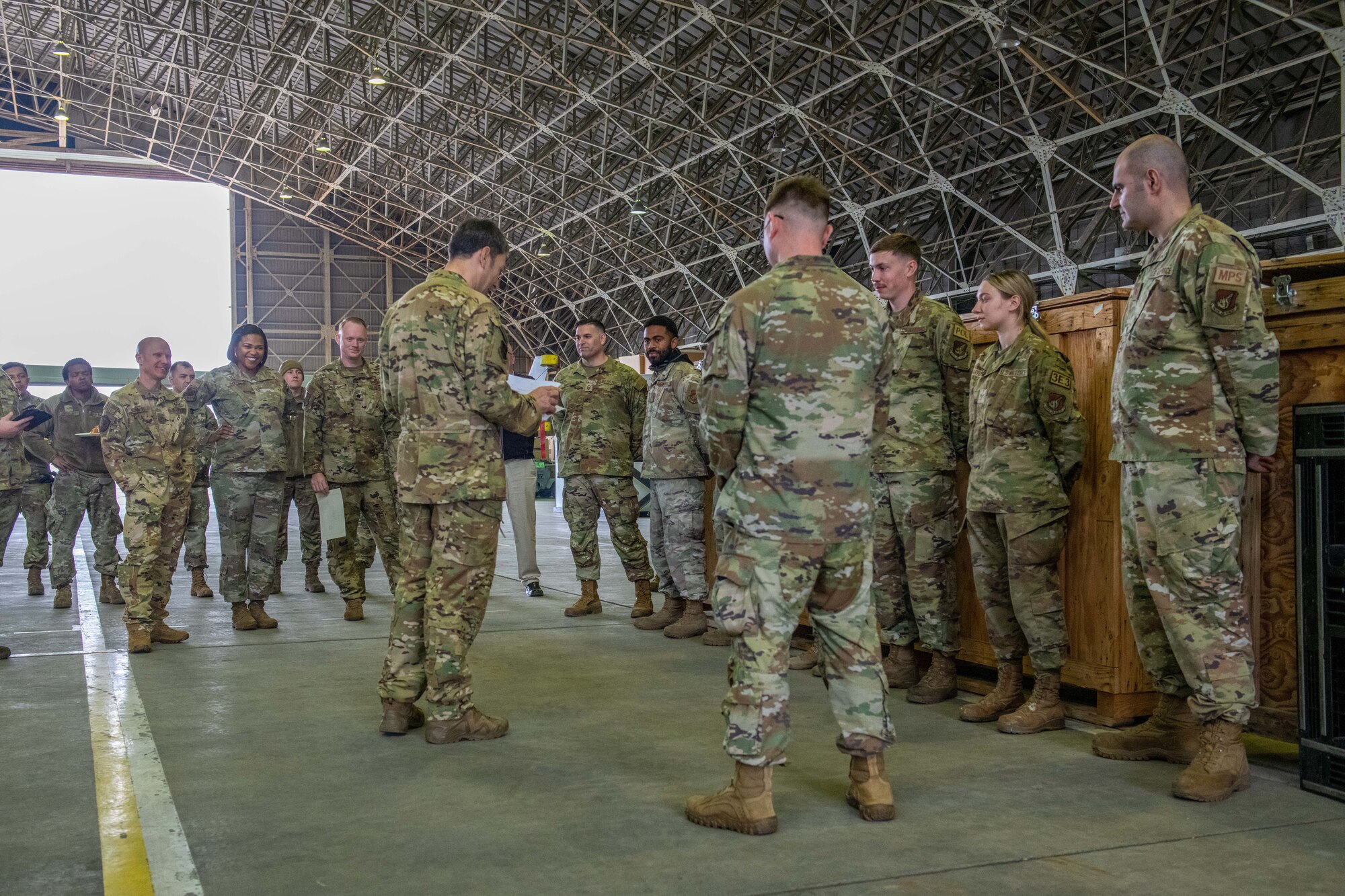 U.S. Air Force Airmen speak in a hangar