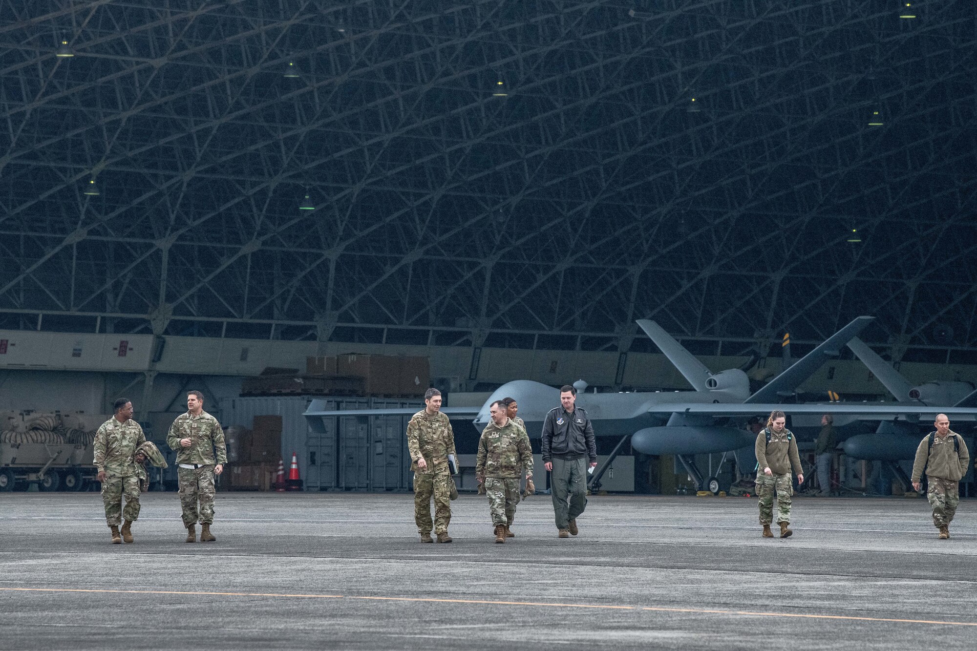 Airmen walk in front of MQ-9 Reaper aircraft