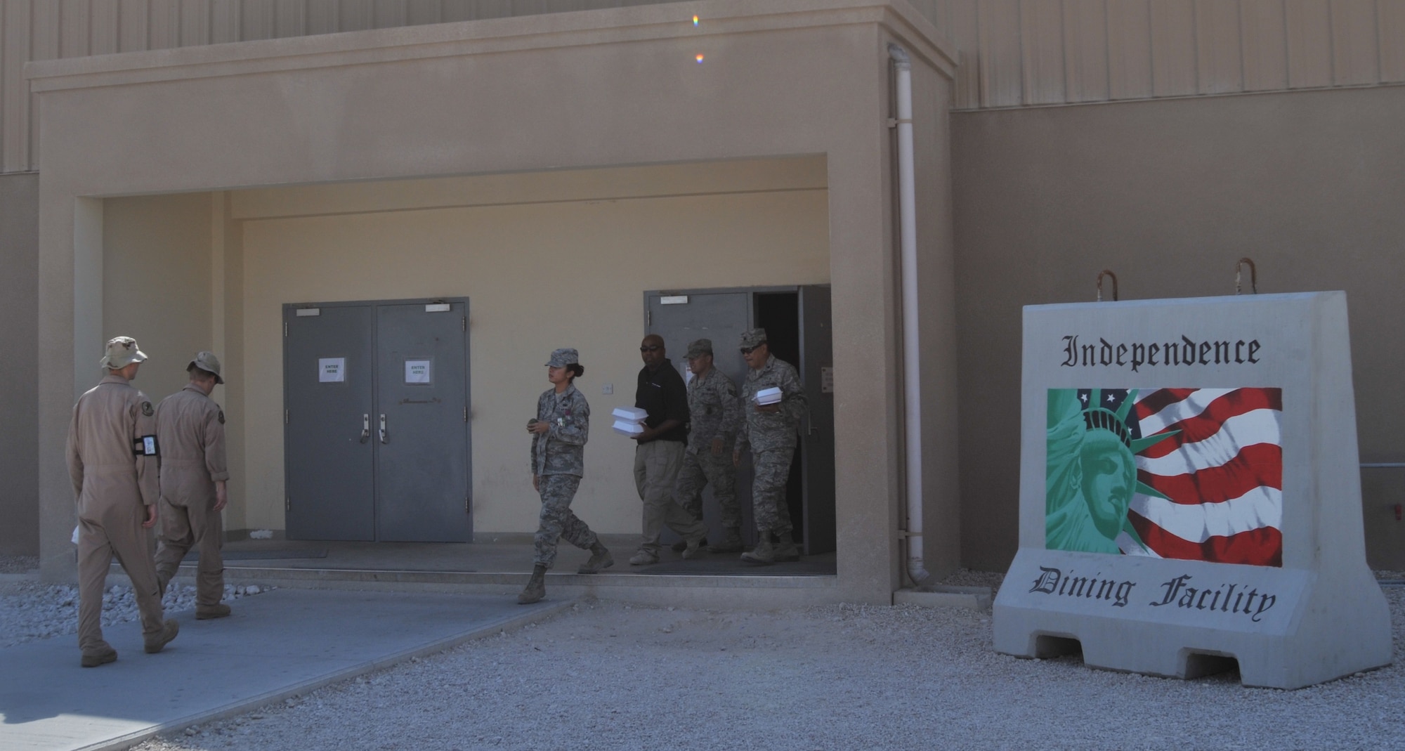 Airmen walk in and out of the dining facility at Al Udeid.