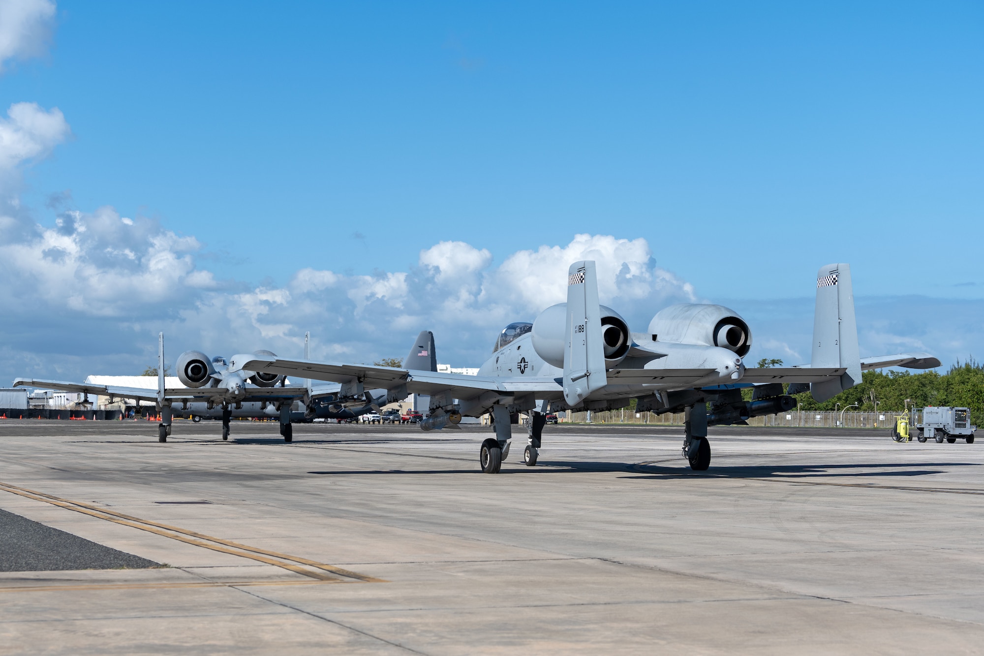 Two U.S. Air Force A-10C Thunderbolt II assigned to the 23rd Air Expeditionary Wing, transit the 156th Wing airfield during the Forward Tiger exercise at Muñiz Air National Guard Base, Carolina, Puerto Rico Feb. 22, 2023. The Puerto Rico Air National Guard provided logistical support, command and control, airfield operations support and hangar space during Operation Forward Tiger, in this exercise, airmen partnered with Dominican Republic, Jamaica and Canadian Forces to enhance the humanitarian assistance and disaster relief mission throughout the Caribbean.  (U.S. Air National Guard photo by Airman 1st Class Gisselle Toro)