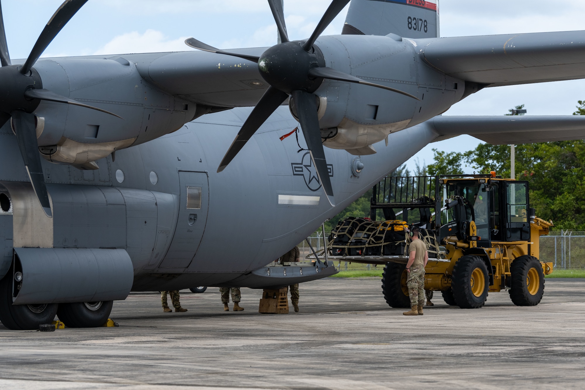 U.S. Airmen load cargo onto a C-130J Super Hercules assigned to the 317th Airlift Wing, Dyess Air Force Base, at Muniz Air National Guard Base, Carolina, Puerto Rico, Feb. 21, 2023. The Puerto Rico Air National Guard provided logistical support, command and control, airfield operations support and hangar space during Operation Forward Tiger exercise, which provides joint training and improves readiness of U.S. and partner nation military personnel through interoperability training. (U.S. Air National Guard photo by Airman 1st Class Gisselle Toro)