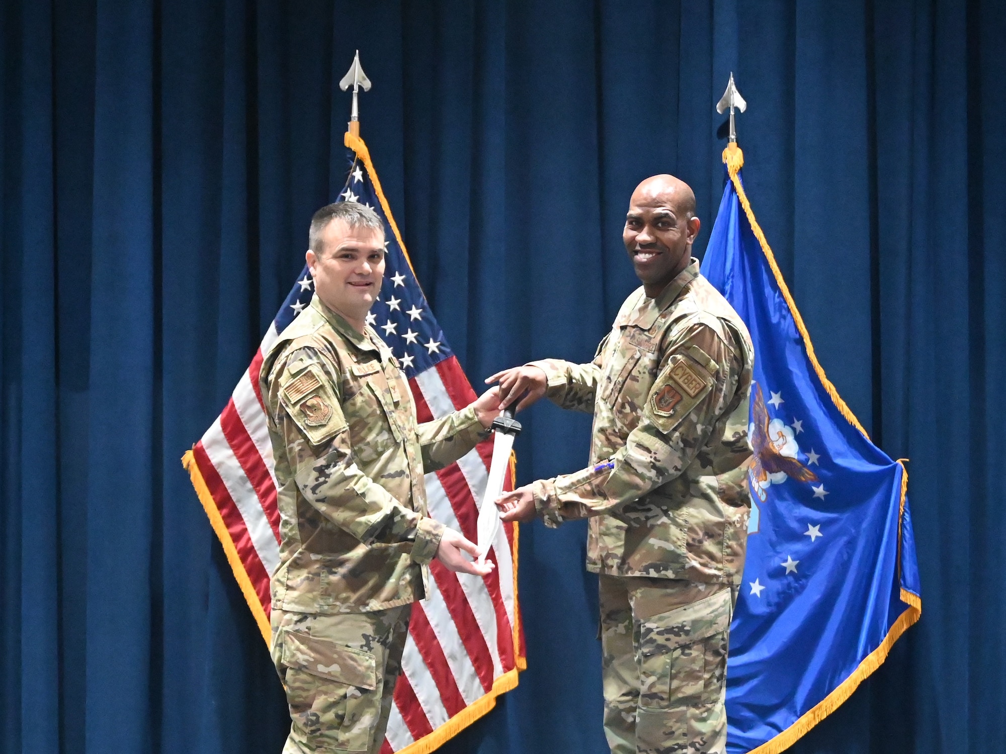 Col. Richard Wallace, 960th Cyber Operations Group commander, presents a rudis sword to Lt. Col. Jarvis Croff, outgoing commander of the 960th Operations Support Flight.