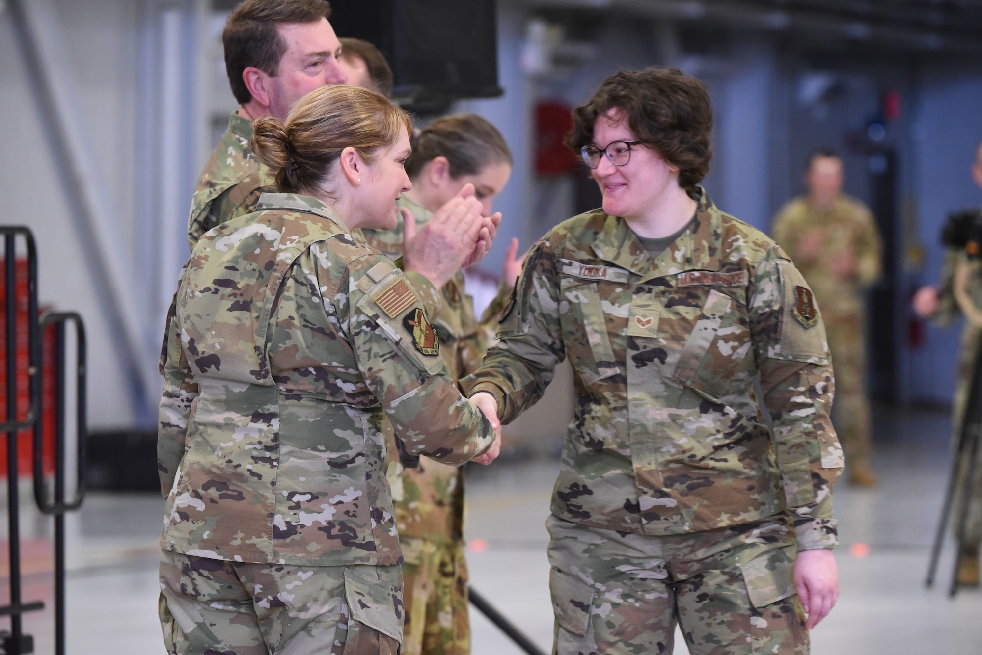 Senior Airman Sophia Yudka shakes hands