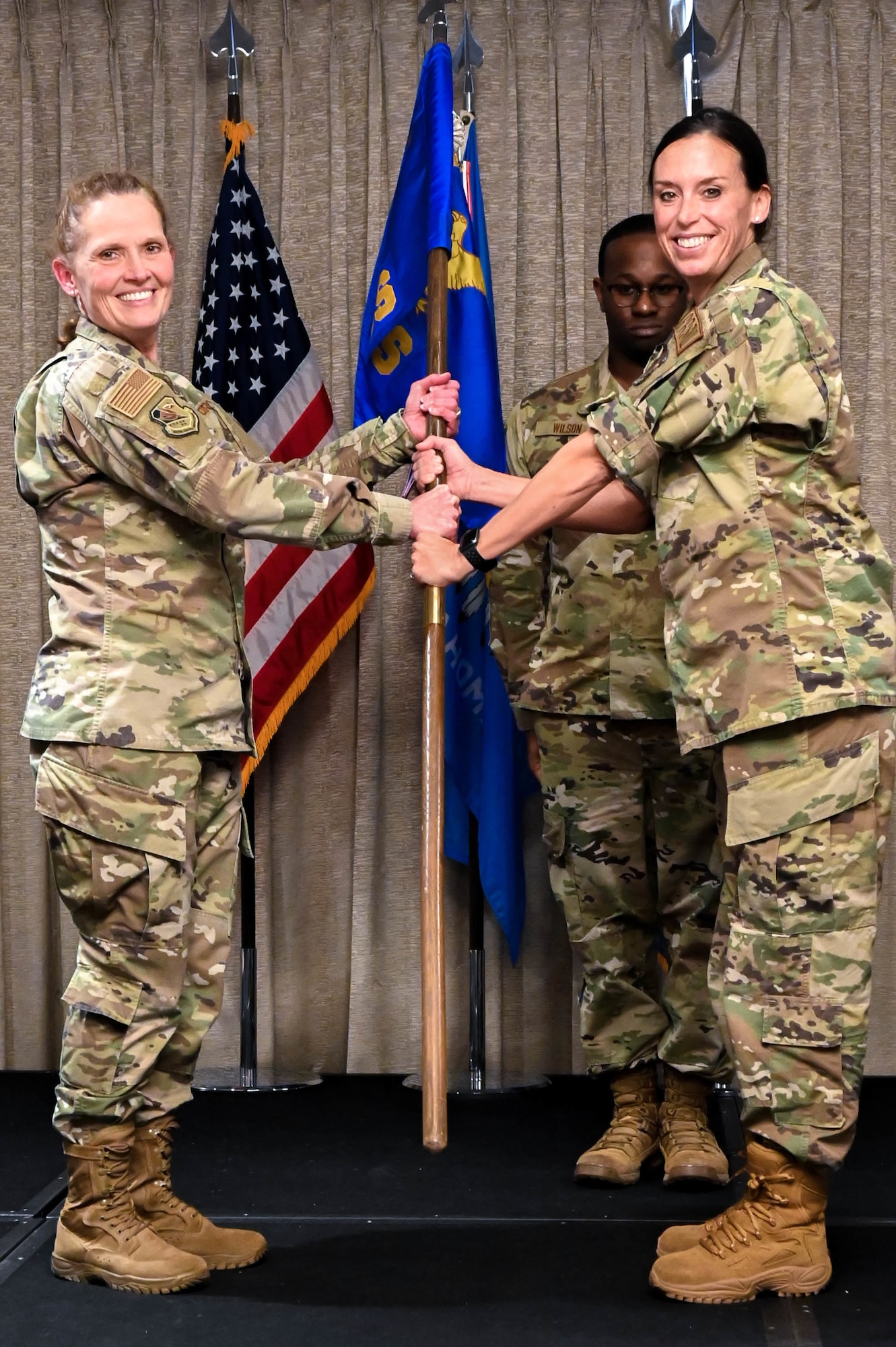 two airmen holding a flag