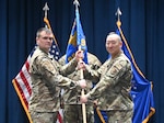 Col. Richard Wallace, 960th Cyber Operations Group commander, presents the leadership guidon to Lt. Col. Andrew Heo.