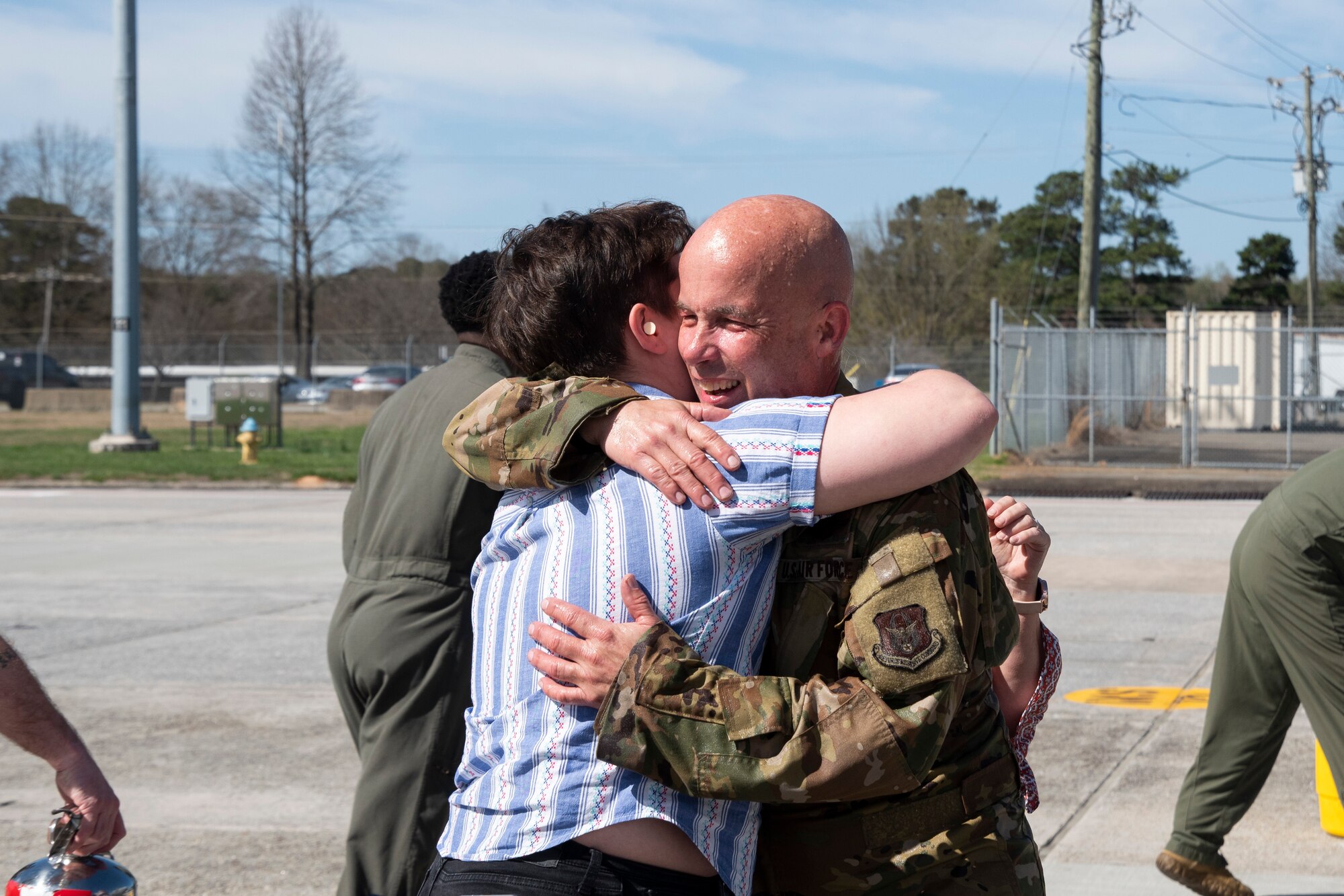 A man and a woman hug one another.
