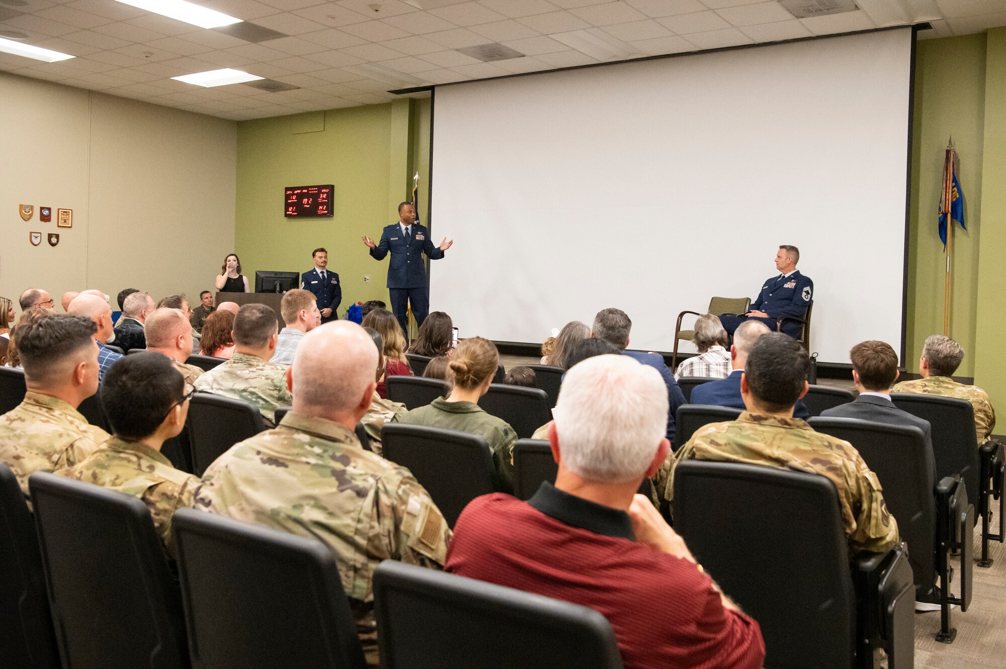 Major Aaron K. Brown gives a speech at Chief Master Sgt. Scott E. Yoder's retirement ceremony.