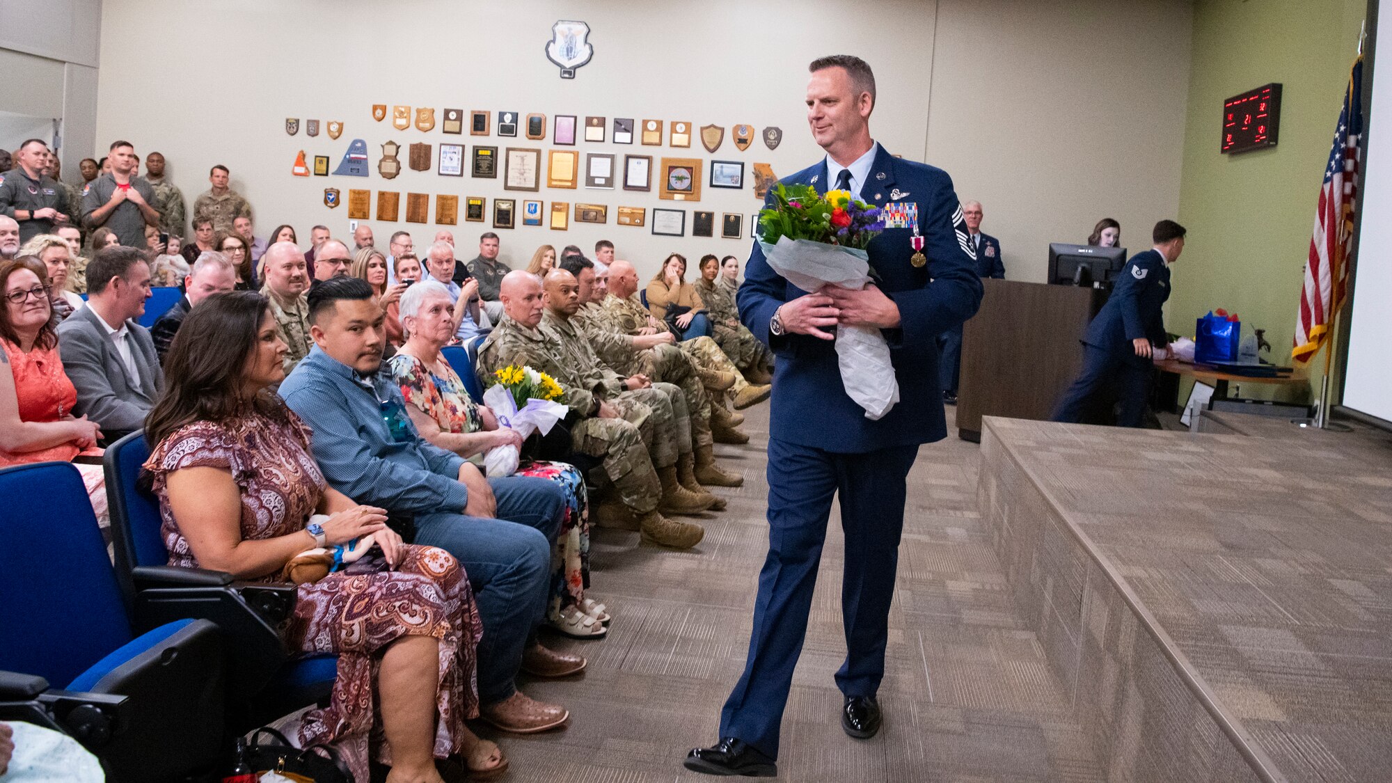 Chief Master Sgt. Scott E. Yoder gives flowers to his family.