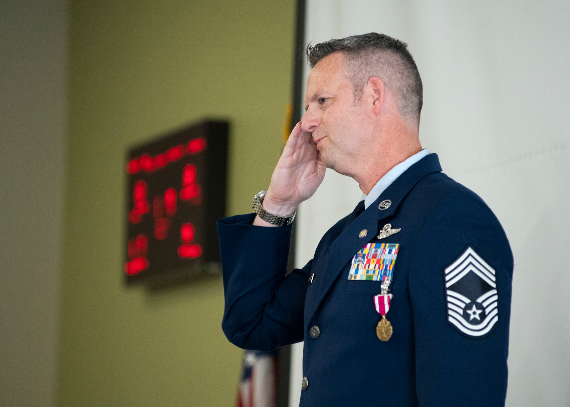 Chief Master Sgt. Scott E. Yoder salutes the audience at his retirement ceremony.