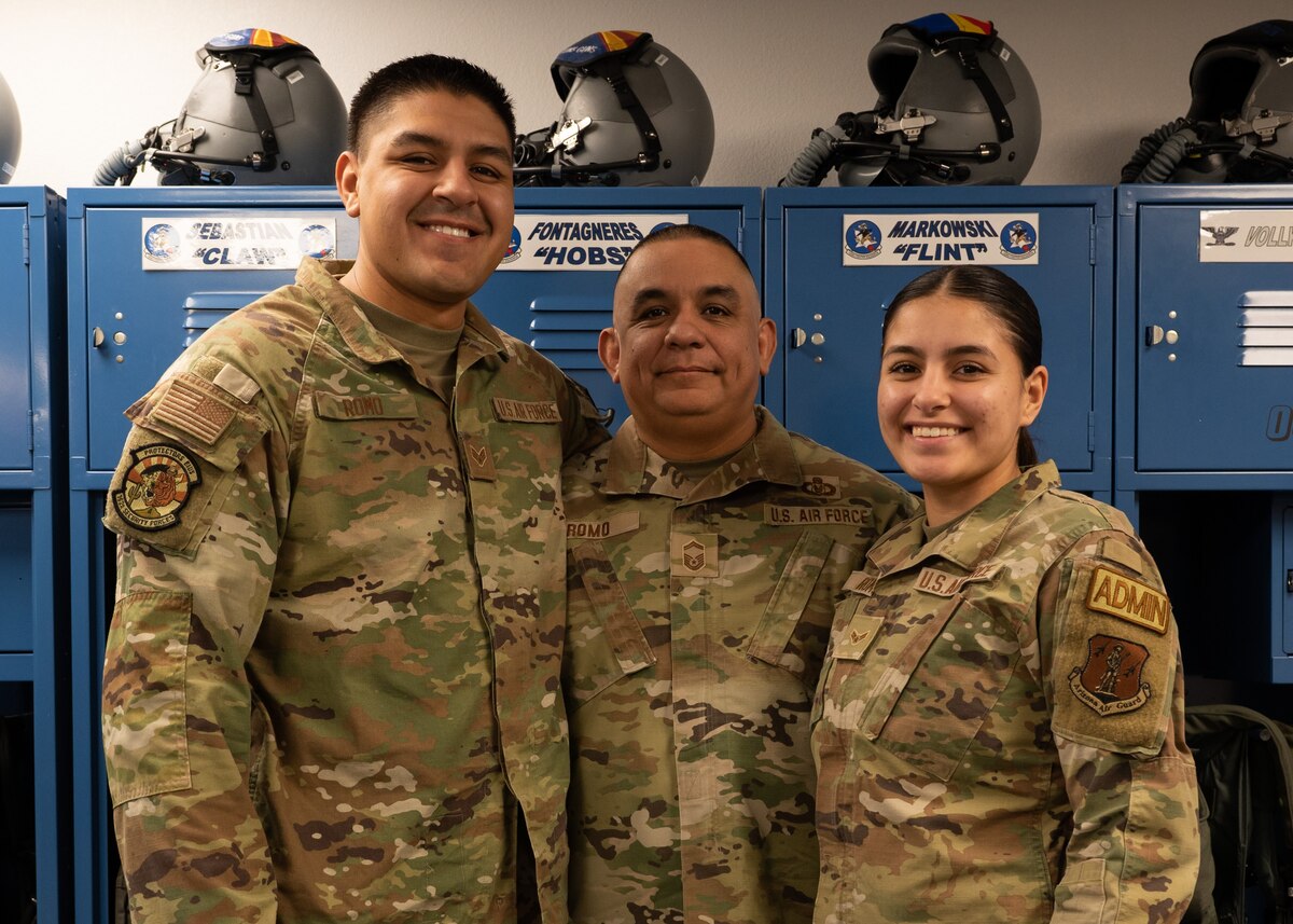 Master Sgt. Lorenzo Romo, Sr., poses with his children, Senior Airman Lorenzo Romo, Jr. and Airman 1st Class Anali Romo at Morris Air National Guard Base in Tucson, Arizona. The Romo children were inspired by their father to join the Arizona Air National Guard, and Anali hopes that her family will one day carry on her military legacy.