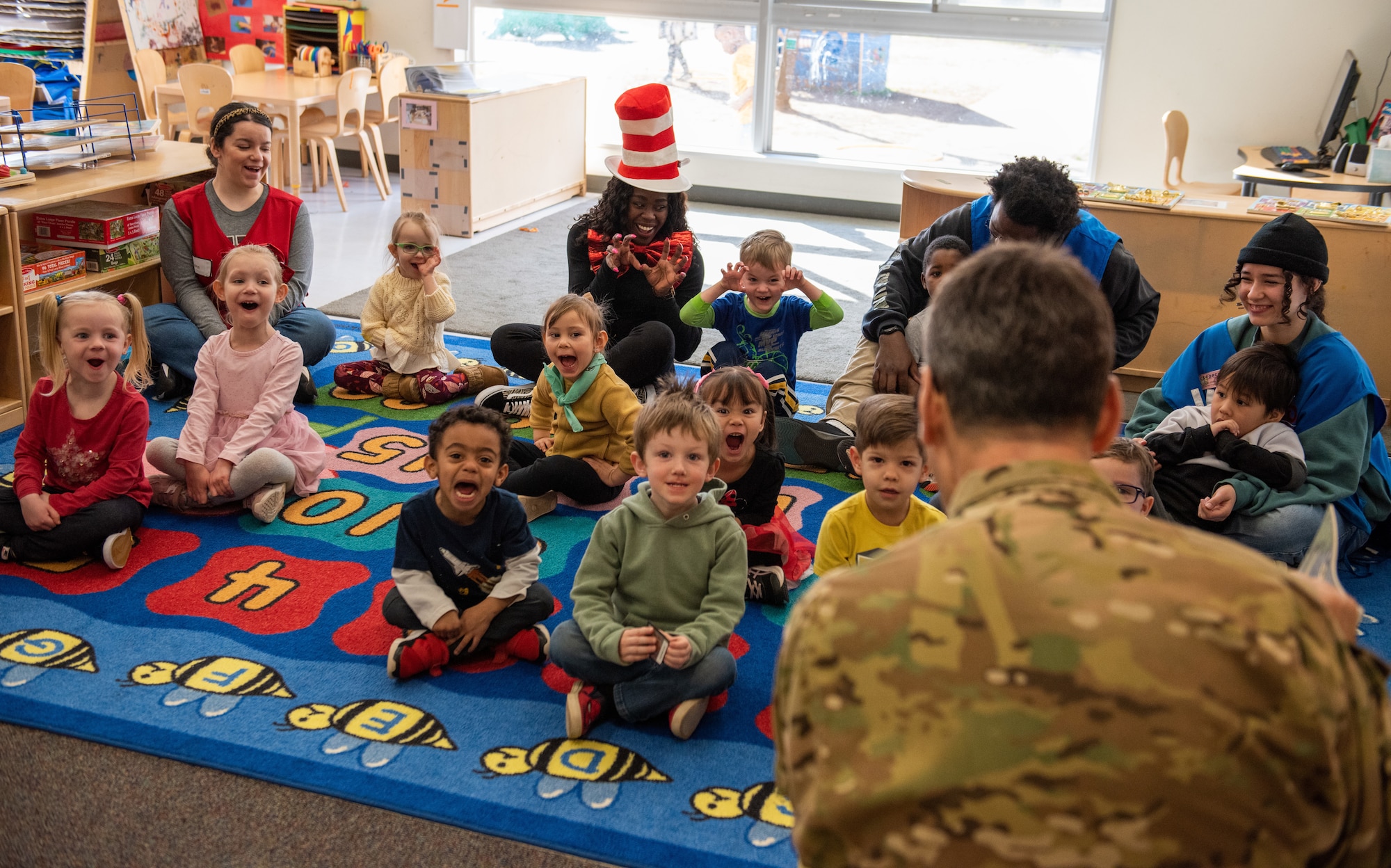 A group of children pretend to roar with their mouths open and hands shaped like claws