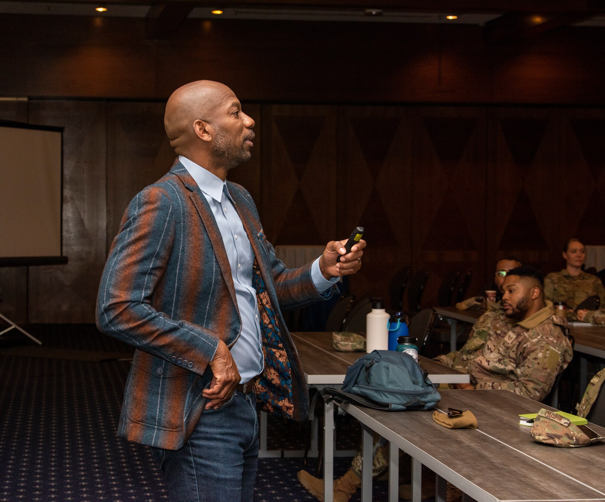 Leadership coach addresses audience at seminar.