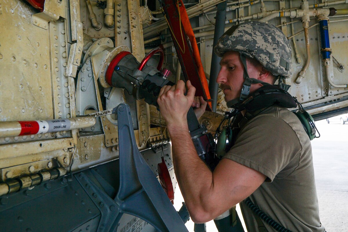 U.S. Air Force Staff Sgt. Christopher Rainer, crew chief with the 186th Air Refueling Wing Fuels Management flight, connects a fuel hose to a KC-135 during a large-scale readiness exercise at the Combat Readiness Training Center, Gulfport, Mississippi, March 1, 2023. The exercise tested Airmen’s ability to respond quickly to adverse situations in a deployed environment.