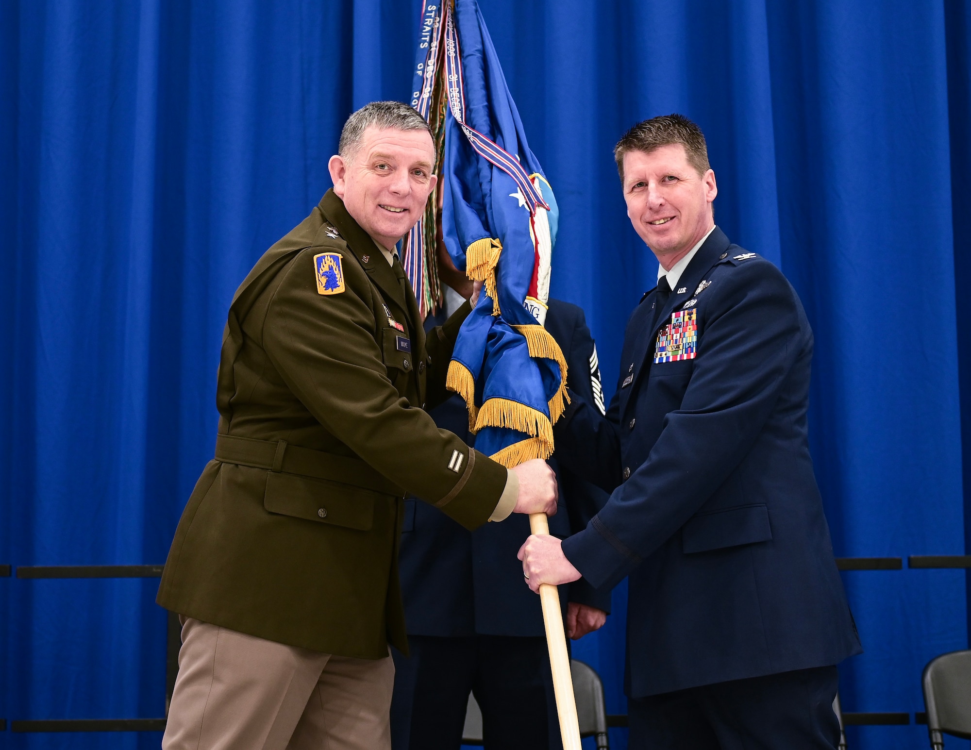 U.S. Air Force Col. Jesse Carlson, right, receives command of the 133rd Airlift Wing from U.S. Army Maj. Gen. Shawn Manke, Adjutant General, Minnesota National Guard, in St. Paul, Minn., March 4, 2023.