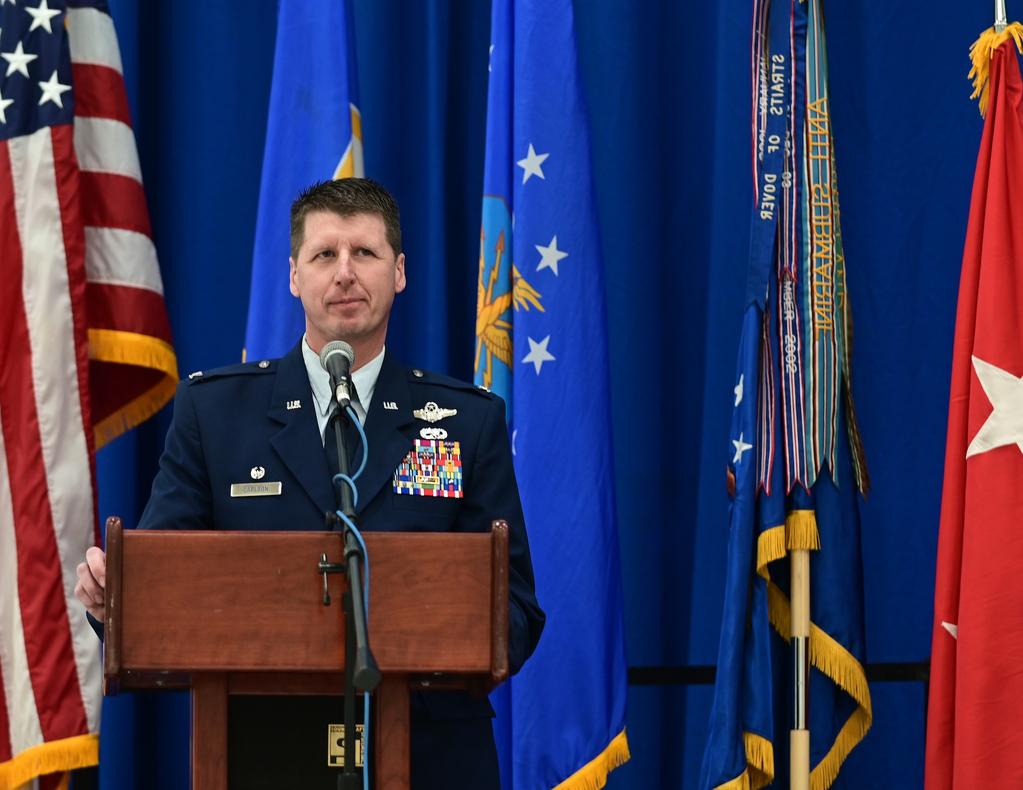 U.S. Air Force Col. Jesse Carlson, 133rd Airlift Wing commander, speaks to Airmen, family, and friends after receiving command in St. Paul, Minn., March 4, 2023.