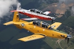 Two T-6B Texan II aircraft fly in formation.