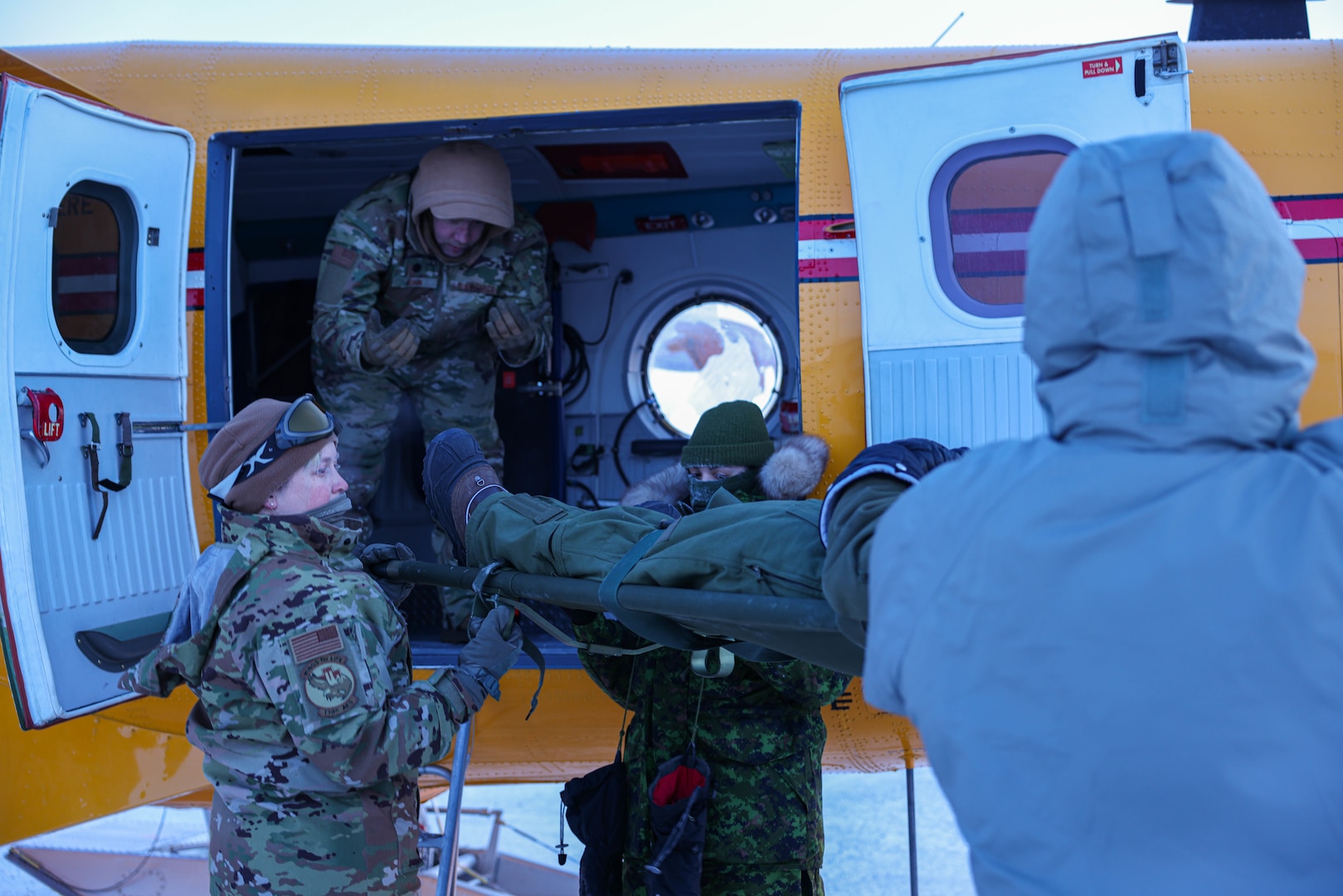 Airmen from the 139th Aeromedical Evacuation Squadron and medics from the Royal Canadian Armed Forces receive quick response training in a de Havilland Canada CC-138  “Twin Otter” aircraft from the 440 Transport Squadron, Royal Canadian Armed Forces in Resolute Bay, Nunavut, Canada, Feb. 26, 2023.