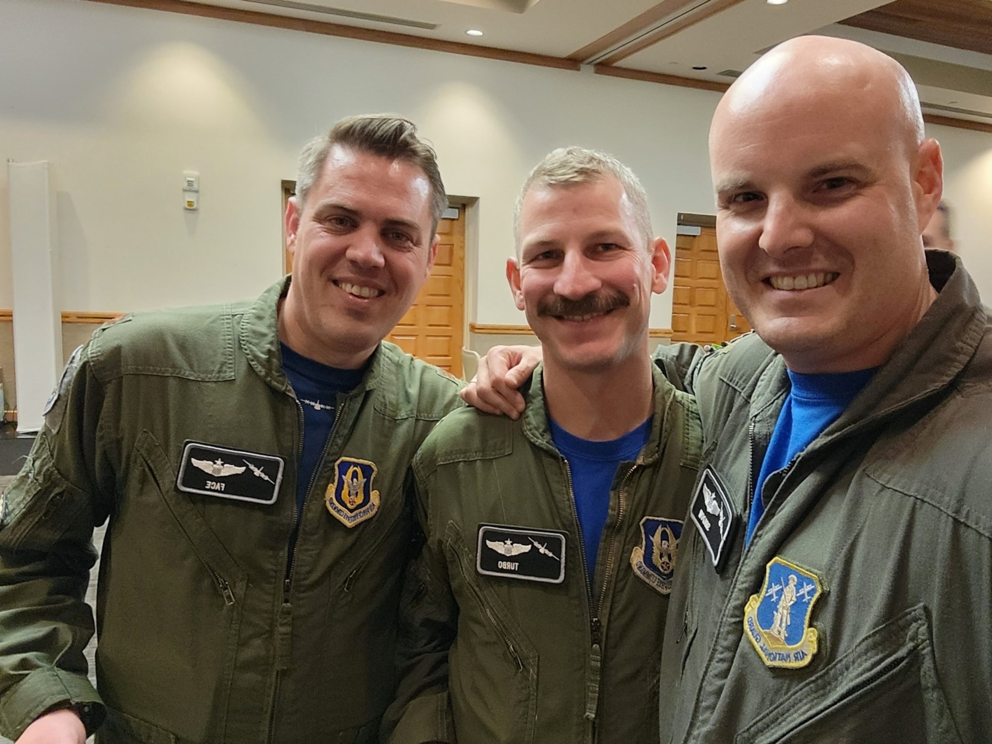 U.S. Air Force Maj. Cristopher “Face” Barber, Maj. Daniel “Turbo” Schei and Maj. Charles “Shadow” Moore pose for a group photo in Nellis Air Force Base, Nev., Dec. 9, 2022.