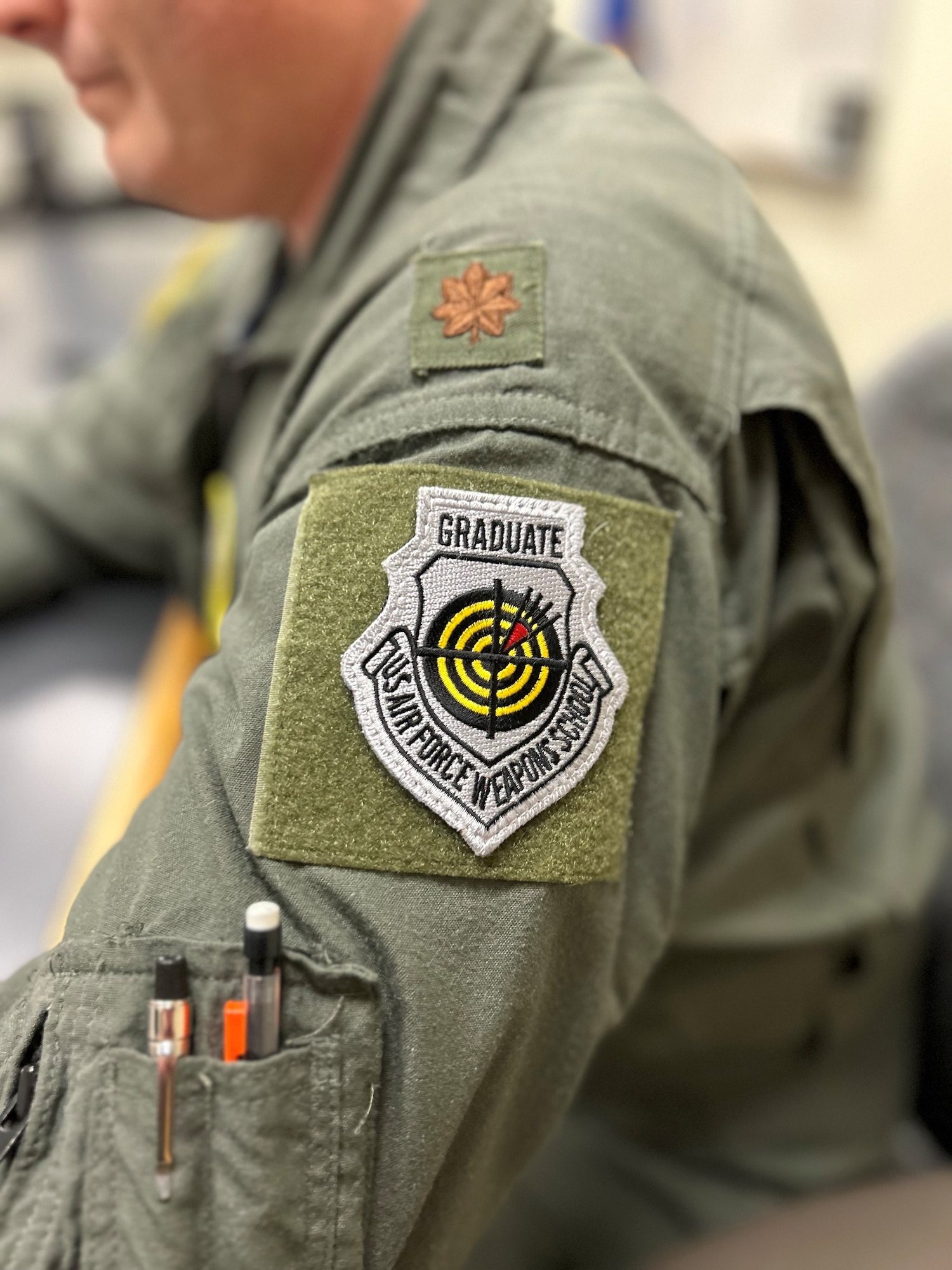U.S. Air Force Maj. Charlie Moore, 133rd Operations Support Squadron Chief of Tactics, proudly wears a C-130 Weapons Instructor course completion patch in St. Paul, Minn., Feb. 4th, 2023.