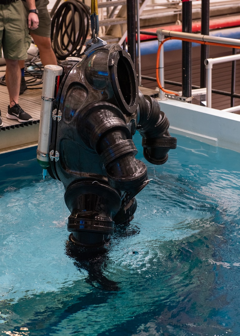 A new concept suit being raised out of the test pool after the Deep Sea Expeditionary with No Decompression (DSEND) Suit In-Water Concept Demonstration held at the U.S. Navy Experimental Diving Unit, Feb. 7 – 8. This new concept would enhance a diver’s range of motion while providing the added benefit of allowing the user to swim independent of propulsion systems. (U.S. Navy photo by Anthony Powers)