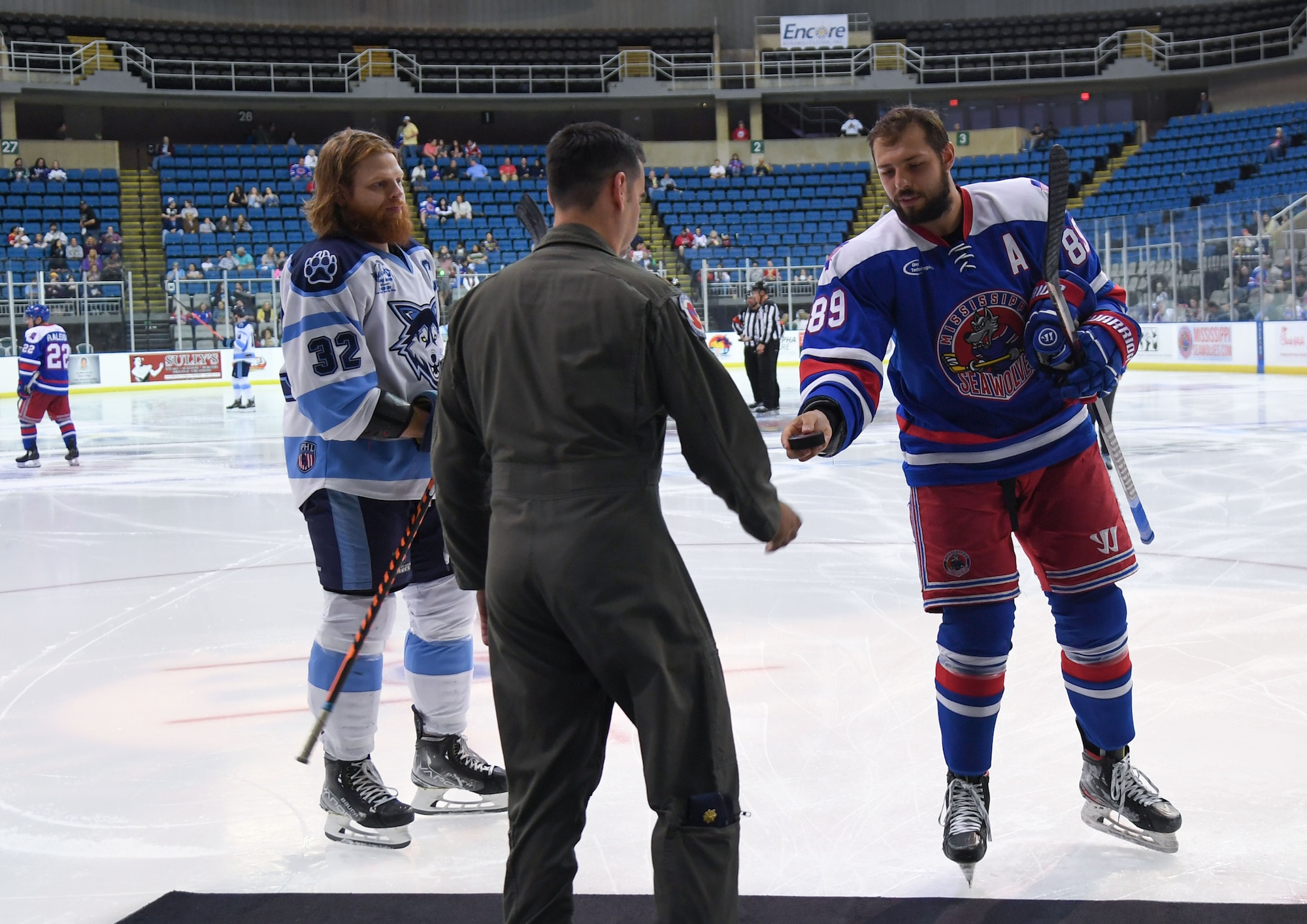 U.S. Air Force Maj. Alex Boykin, 53rd Weather Reconnaissance Squadron pilot, participates in a ceremonial puck drop during the Biloxi Pro Hockey game inside the Mississippi Coast Coliseum at Biloxi, Mississippi, March 3, 2023.