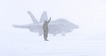 NAVAL AIR FACILITY MISAWA, Japan (Jan. 10, 2013) A groundcrew member from Electronic Attack Squadron (132) signals to an EA-18G Growler as it returns from a flight during heavy snows at Naval Air Facility Misawa. VAQ-132 is currently finishing up a six-month deployment here in support of U.S. 7th Fleet. (U.S. Navy photo by Mass Communication Specialist 1st Class Kenneth G. Takada/Released)