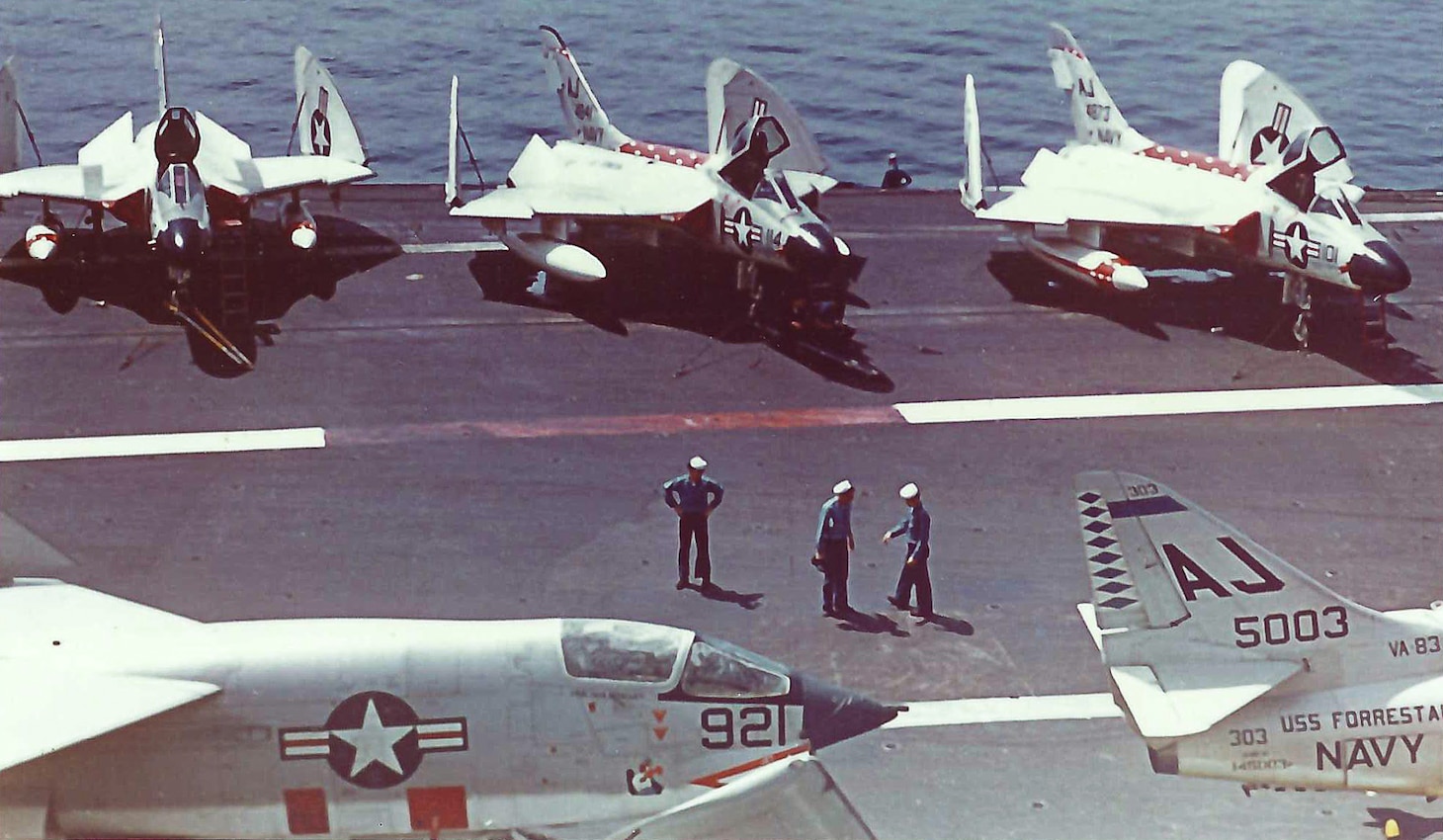 F4D Skyrays of Fighting Squadron (VF) 102 line the flight deck of the USS Forrestal (CVA 59) during a Med cruise in 1960. An F8U-1P (later RF-8A, post-October 1962) Crusader of VFP-62 and an A4D-2 (later A-4B, post-October 1962, of Attack Squadron 83) Skyhawk share the deck in the foreground.