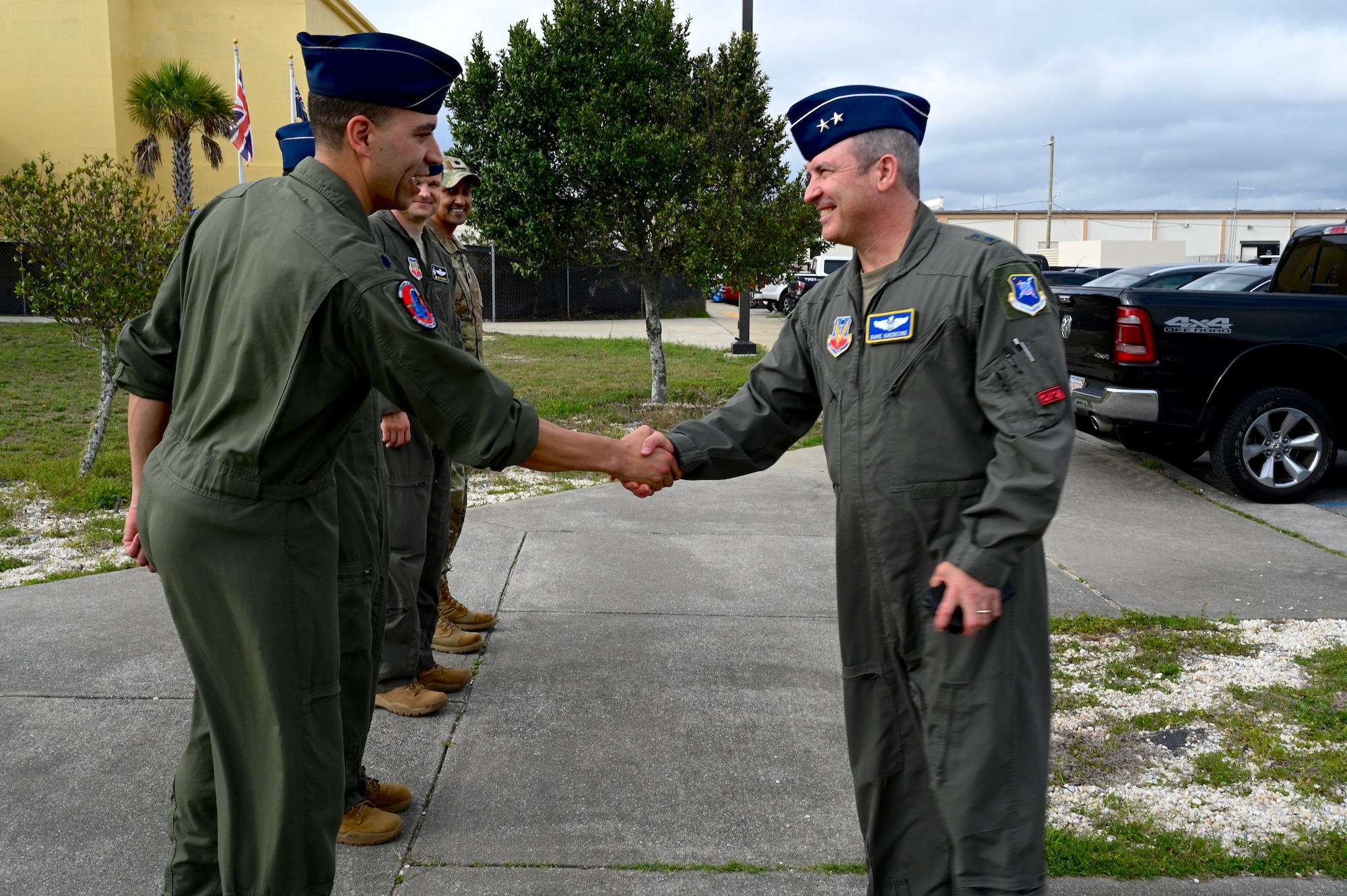 U.S. Air Force Lt. Col. Ronnie Smith, 39th Electronic Warfare Squadron commander, left, greets U.S. Air Force Maj. Gen. David Gaedecke, 16th Air Forces (Air Forces Cyber) vice commander, right, to the 350th Spectrum Warfare Wing at Eglin Air Force Base, Fla., March 1, 2023. During the visit, Crows showcased a variety of missions such as ACEWIRE, the COMBAT SHIELD mission, the F-35 Program and more that are helping to shape the future of warfare. (U.S. Air Force photo by 1st Lt. Benjamin Aronson)