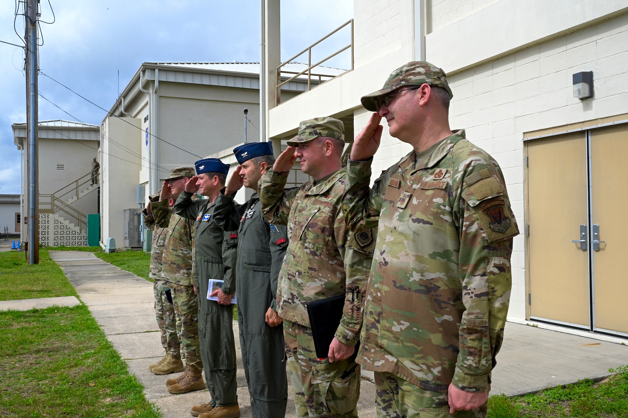 Leadership from the 350th Spectrum Warfare Wing salute as U.S. Air Force Maj. Gen. David Gaedecke, 16th Air Forces (Air Forces Cyber) vice commander, arrives for a visit at Eglin Air Force Base, Fla., March 1, 2023. During the visit, Crows showcased a variety of missions such as ACEWIRE, the COMBAT SHIELD mission, the F-35 Program and more that are helping to shape the future of warfare. (U.S. Air Force photo by 1st Lt. Benjamin Aronson)