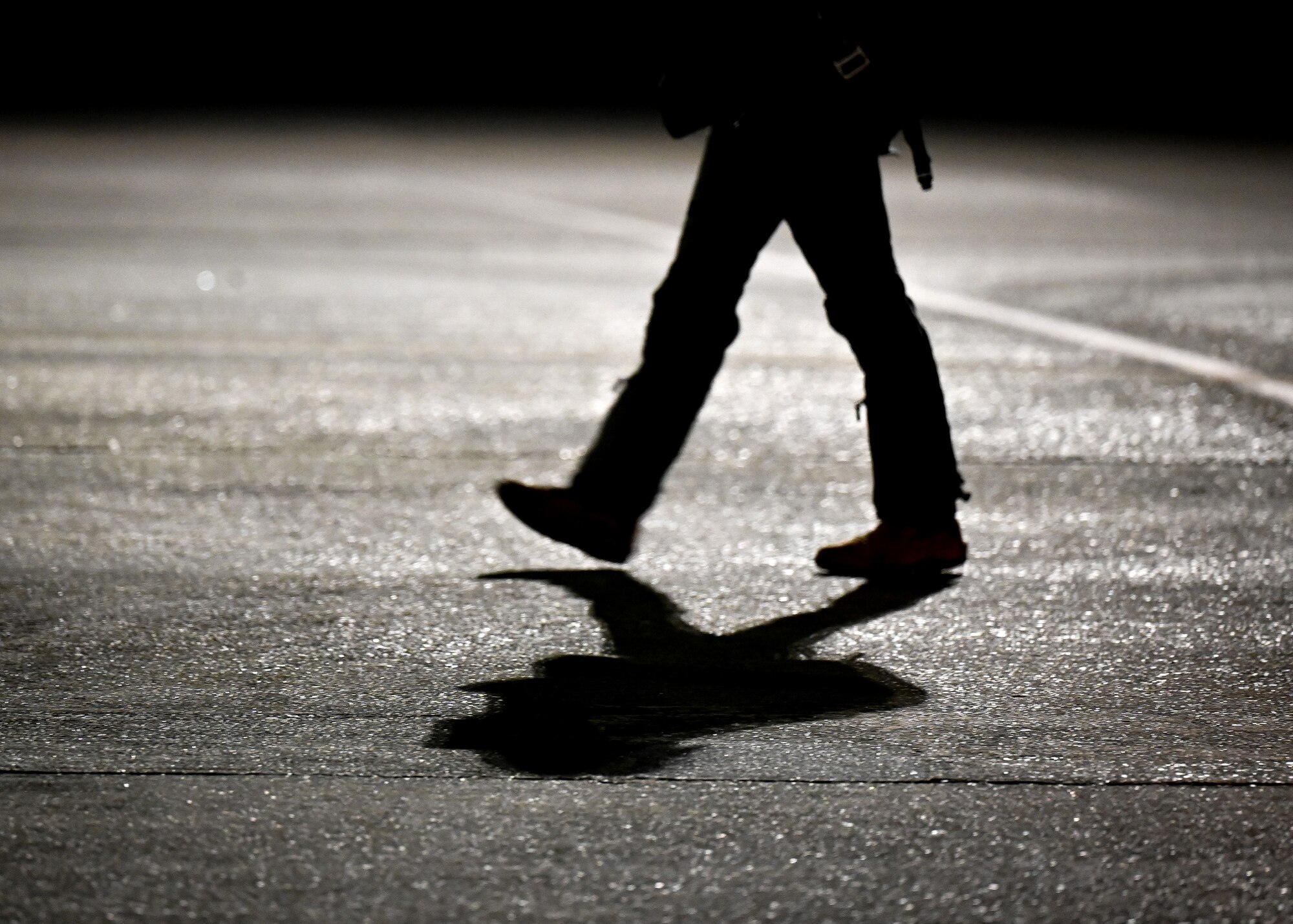 photo of the shadow of a pilot walking