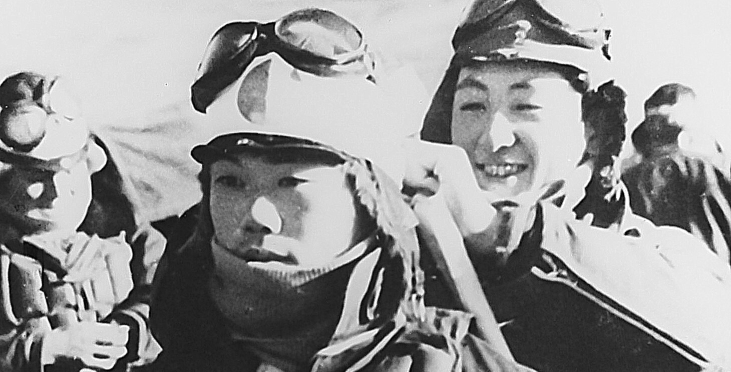 At their base in the Philippines, showing both the solemnity and eager anticipation of their coming mission, a young Kamikaze pilot waits for his comrade to tie his hachimaki around his head. Frequently worn by flight crews, this ancient personal banner symbolized a warrior’s composure before combat.