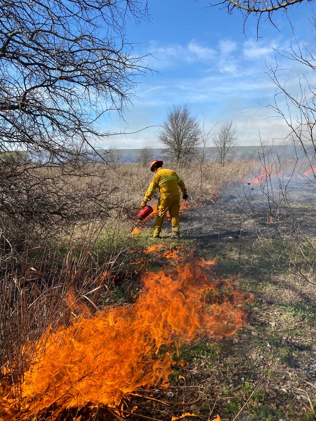 Showing prescribed burn operations with fire burning at Reynolds Creek, Waco Lake, Texas.