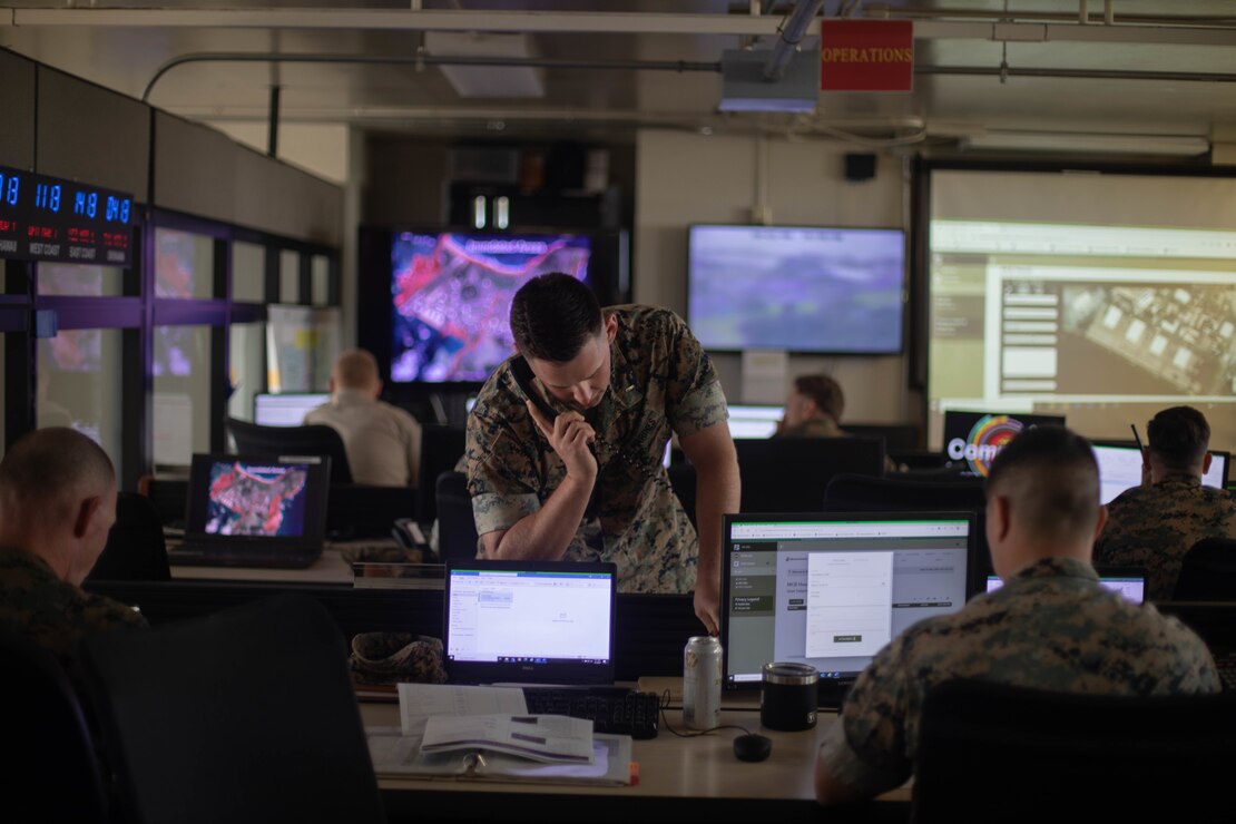 U.S. Marine Corps 1st Lt. Cole Bailey, infantry officer, 3d Marine Littoral Regiment, 3d Marine Division, provides coordinating instructions during the Nui Nalu 2023 Command Post Exercise, Marine Corps Base Hawaii, March 1, 2023. This exercise allowed MCBH units and sections to practice Emergency Operations Center procedures and include the use of the new Marine Corps Common Operational Picture Application to manage resources in response to the notionally approaching tsunami. (U.S. Marine Corps photo by Lance Cpl. Clayton Baker)