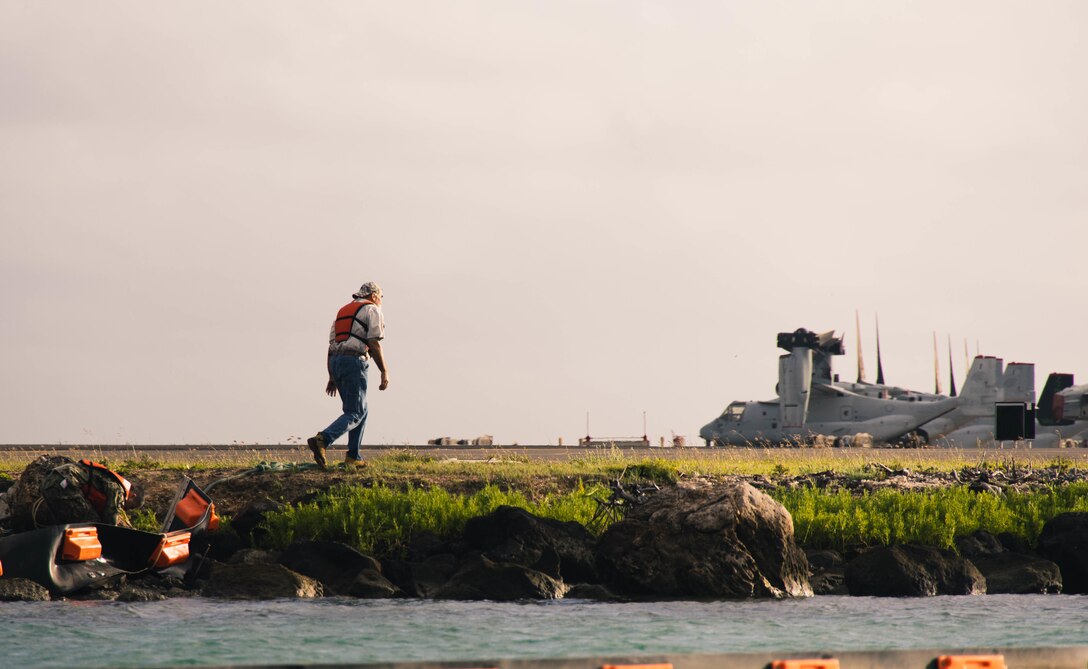 David Carter, environmental coordinator, Environmental Compliance and Protection Division, Marine Corps Base Hawaii, prepares to deploy a water boom during a simulated fuel spill reaction drill, MCBH, Feb. 24, 2023. The drill consisted of a no-notice emergency call to respond to a notional fuel spill in Kaneohe Bay in which the priority was to contain and remove harmful toxins from the water. WFO provides MCBH with waterborne search and rescue capabilities and serves as the installation's emergency response team. (U.S. Marine Corps photo by Cpl. Brandon Aultman)