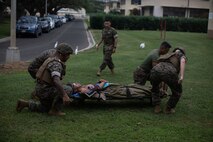 U.S. Navy Sailors with Bravo Surgical Company, 3rd Medical Battalion, transport a patient during a simulated casualty care exercise, Marine Corps Base Hawaii, Feb. 23, 2023. The event displayed the medical capabilities of Bravo Surgical company to U.S. Marine Forces, Pacific and the Japanese Self-Defense Force National Defense Medical College. (U.S. Marine Corps photo by Lance Cpl. Clayton Baker)