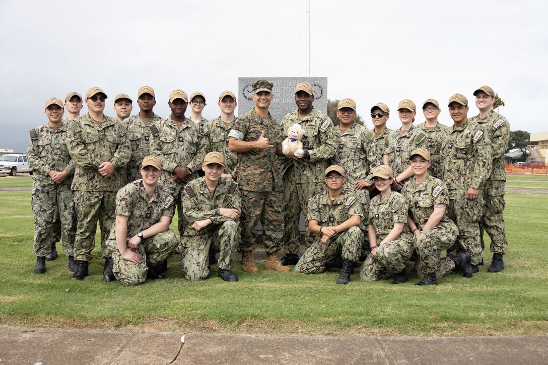 U.S. Navy Sailors assigned to the USS John Finn (DDG 113) pose for a group photo with U.S. Marine Corps Col. Speros Koumparakis, commanding officer, Marine Corps Base Hawaii, during a tour around MCBH, Feb. 21, 2023. The purpose of the visit was to provide a visual and historic understanding of the attacks that occurred on Naval Air Station Kaneohe Bay on Dec. 7, 1941, in which U.S. Navy Chief Petty Officer John Finn’s acts of heroism earned him the Congressional Medal of Honor. (U.S. Marine Corps photo by Cpl. Brandon Aultman)