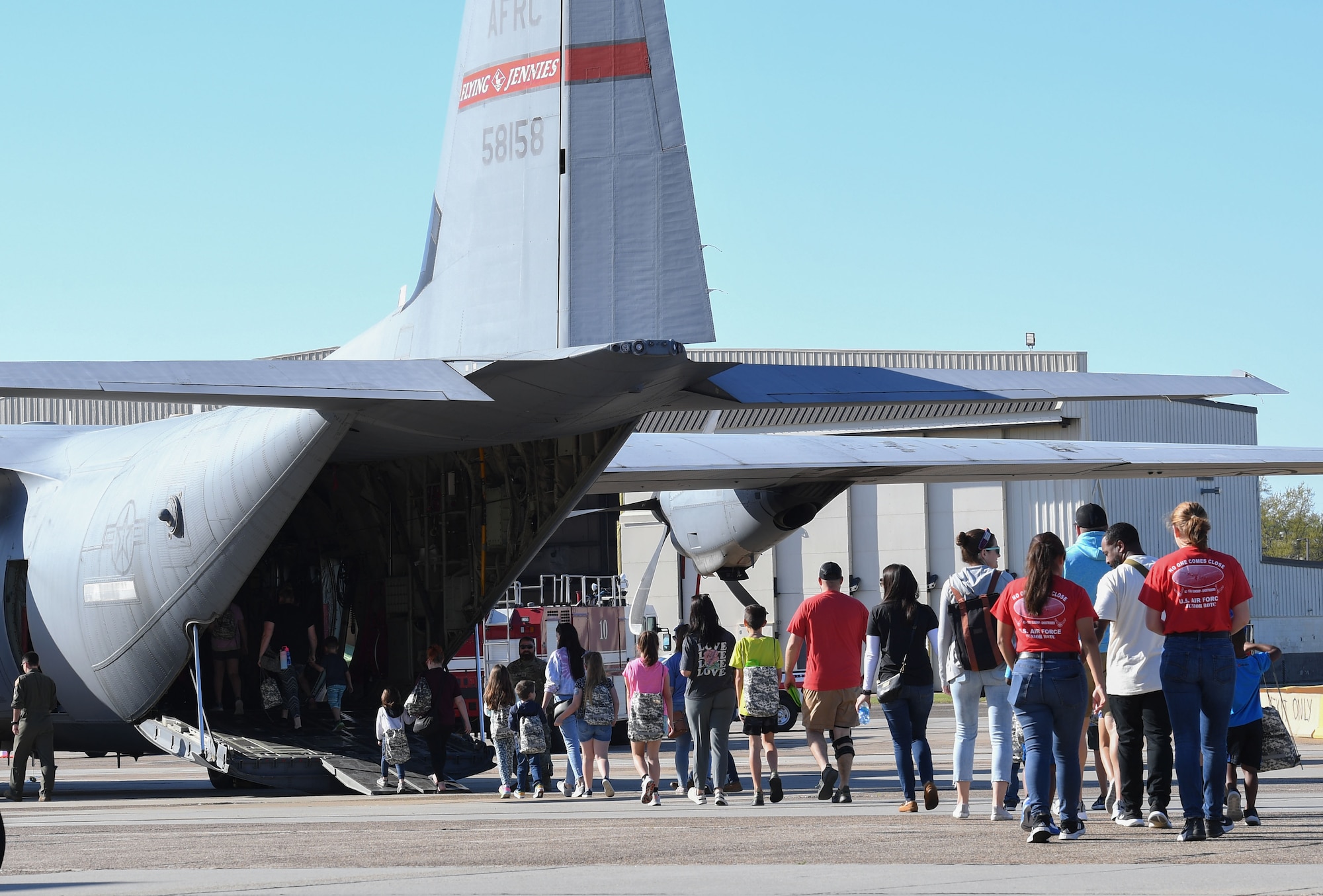 Keesler families make their way onto a W-C130 aircraft during Operation Hero at Keesler Air Force Base, Mississippi, March 4, 2023.
