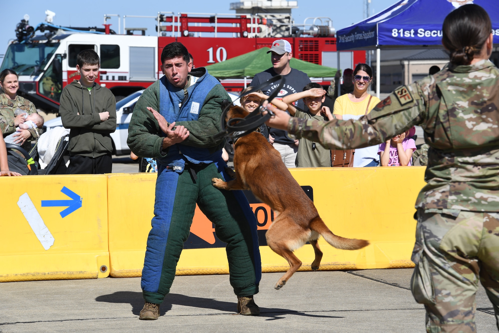 U.S. Air Force Staff Sgts. Anthony Seretis and Ryan Wood, 81st Security Forces Squadron military working dog handlers, and Victor, 81st SFS military working dog, provide a demonstration during Operation Hero at Keesler Air Force Base, Mississippi, March 4, 2023.