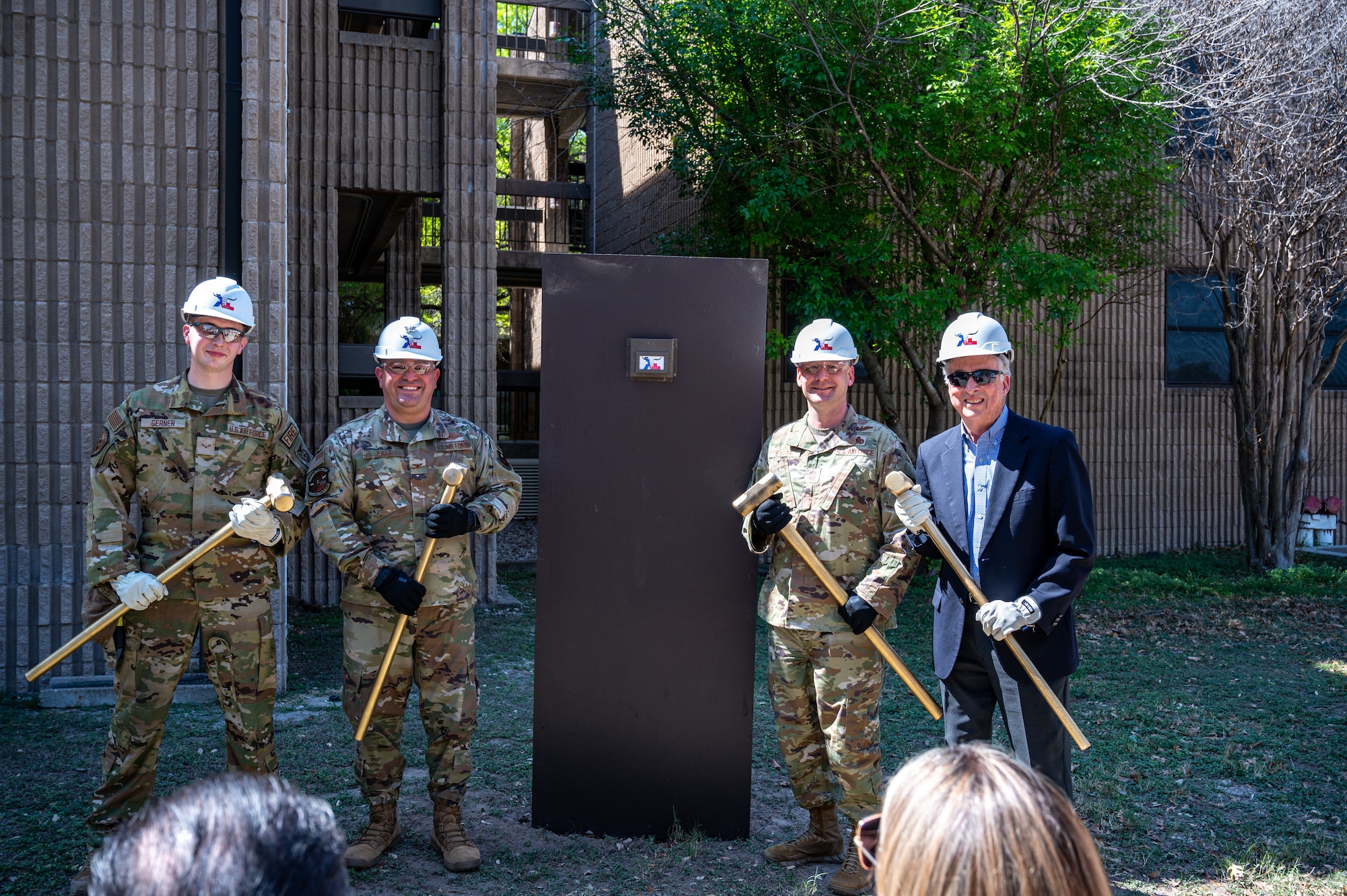 (from left to right) U.S. Air Force Airman 1st Class Johnathan, 47th Civil Engineering Squadron, Col. Andrew Catz, 47th Flying Training Wing vice commander, Chief Master Sgt. David Snarr, 47th Flying Training Wing command chief, Lonnie Ricks pose for a photo to be in the renovation of Ricks Hall dormitory at Laughlin Air Force Base, Texas, on Mar. 06, 2023. The Air Force Civil Engineer Center funded this $35.3 million project. It will contribute to improving the base and give Airmen the ability to perform better by going home to a comfortable living space at the end of their day. (U.S. Air Force photo by Senior Airman David Phaff)