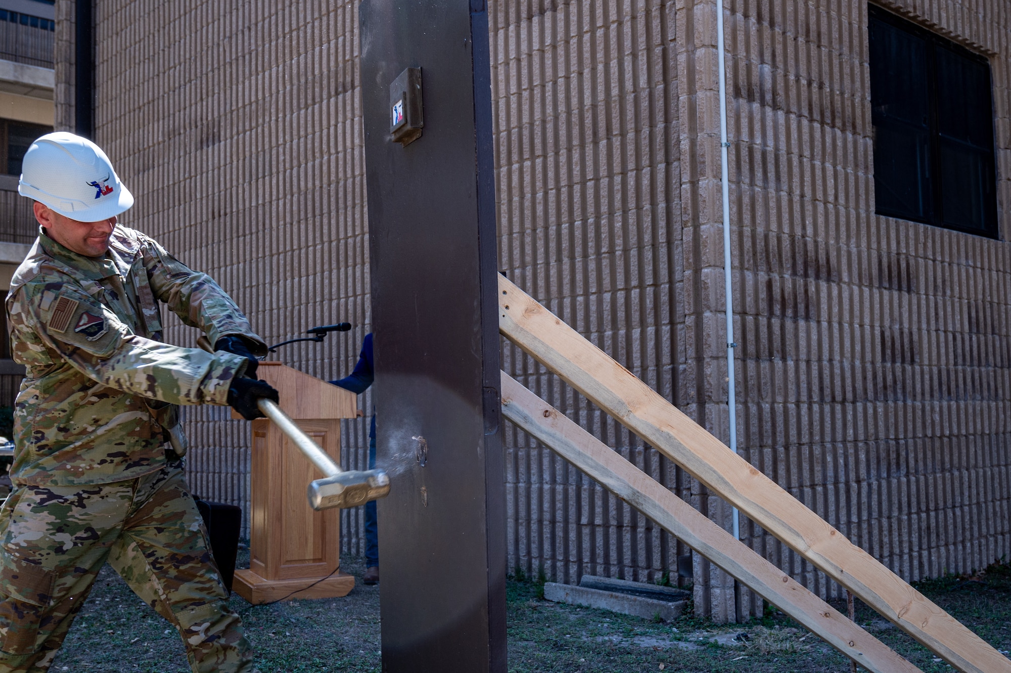 U.S. Air Force Chief Master Sgt. David Snarr, 47th Flying Training Wing command chief, swings a hammer to bring in the beginning of new construction at the Ricks Hall dormitory at Laughlin Air Force Base, Texas, on Mar. 6, 2023. The Air Force Civil Engineer Center funded this $35.3 million project. It will contribute to improving the base and give Airmen the ability to perform better by going home to a comfortable living space at the end of their day. (U.S. Air Force photo by Senior Airman David Phaff)