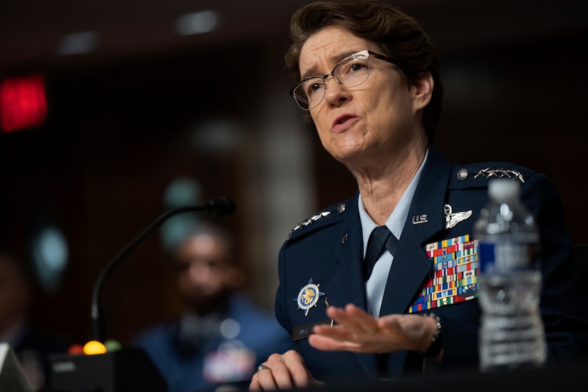 A woman in military dress uniform speaks.