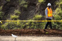 A construction worker surveys the excavation site during Operational Range Clearance and Maintenance on Marine Corps Base Hawaii, Pu’uloa Training Facility, Foxtrot Range, Feb. 23, 2023. The ORC serves to remove unexploded ordinance and range debris from the operational ranges and the mining of munitions from the impact berms on ranges. Routine clearance and maintenance ensure the safety and sustainability of Marine Corps ranges and training areas. (U.S. Marine Corps photo by Cpl. Samantha Sanchez)