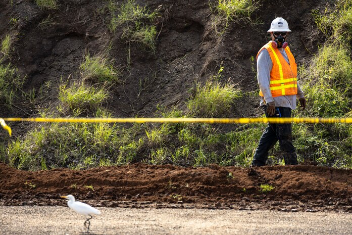 A construction worker surveys the excavation site during Operational Range Clearance and Maintenance on Marine Corps Base Hawaii, Pu’uloa Training Facility, Foxtrot Range, Feb. 23, 2023. The ORC serves to remove unexploded ordinance and range debris from the operational ranges and the mining of munitions from the impact berms on ranges. Routine clearance and maintenance ensure the safety and sustainability of Marine Corps ranges and training areas. (U.S. Marine Corps photo by Cpl. Samantha Sanchez)