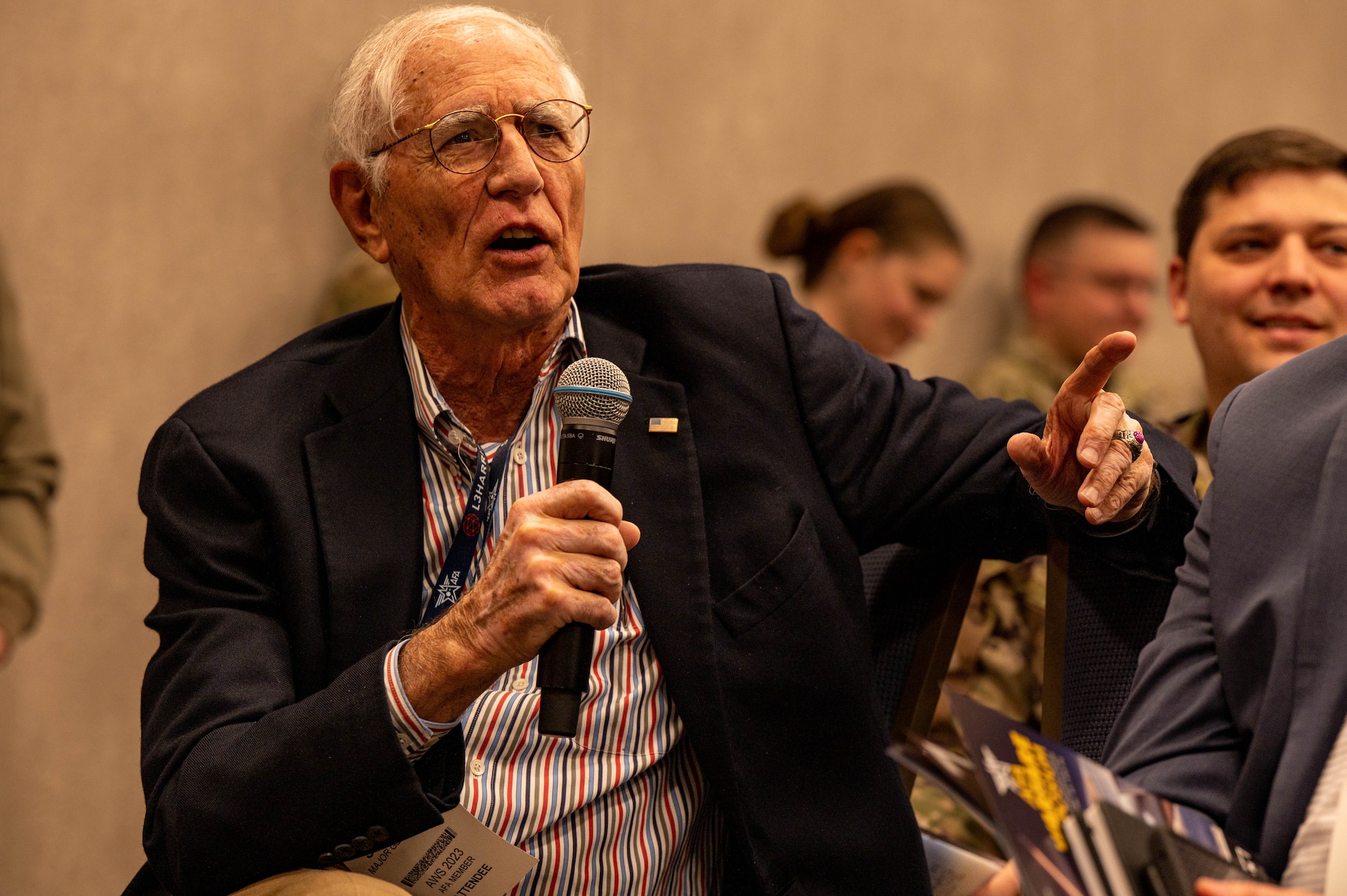 A man holds a microphone.