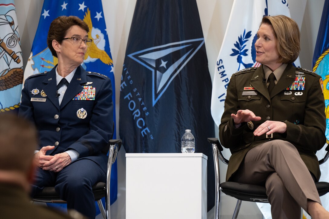 U.S. Air Force Gen. Jacqueline Van Ovost, U.S. Transportation Command commander, left, and U.S. Army Gen. Laura Richardson, U.S. Southern Command commander, answer questions during a Women's History Month panel discussion at the Military Women's Memorial in Arlington National Cemetery, Arlington, Va., March 6, 2023.