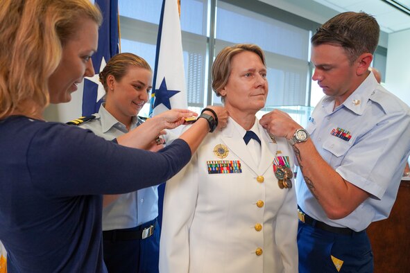 Four people in military uniform hold a discussion.