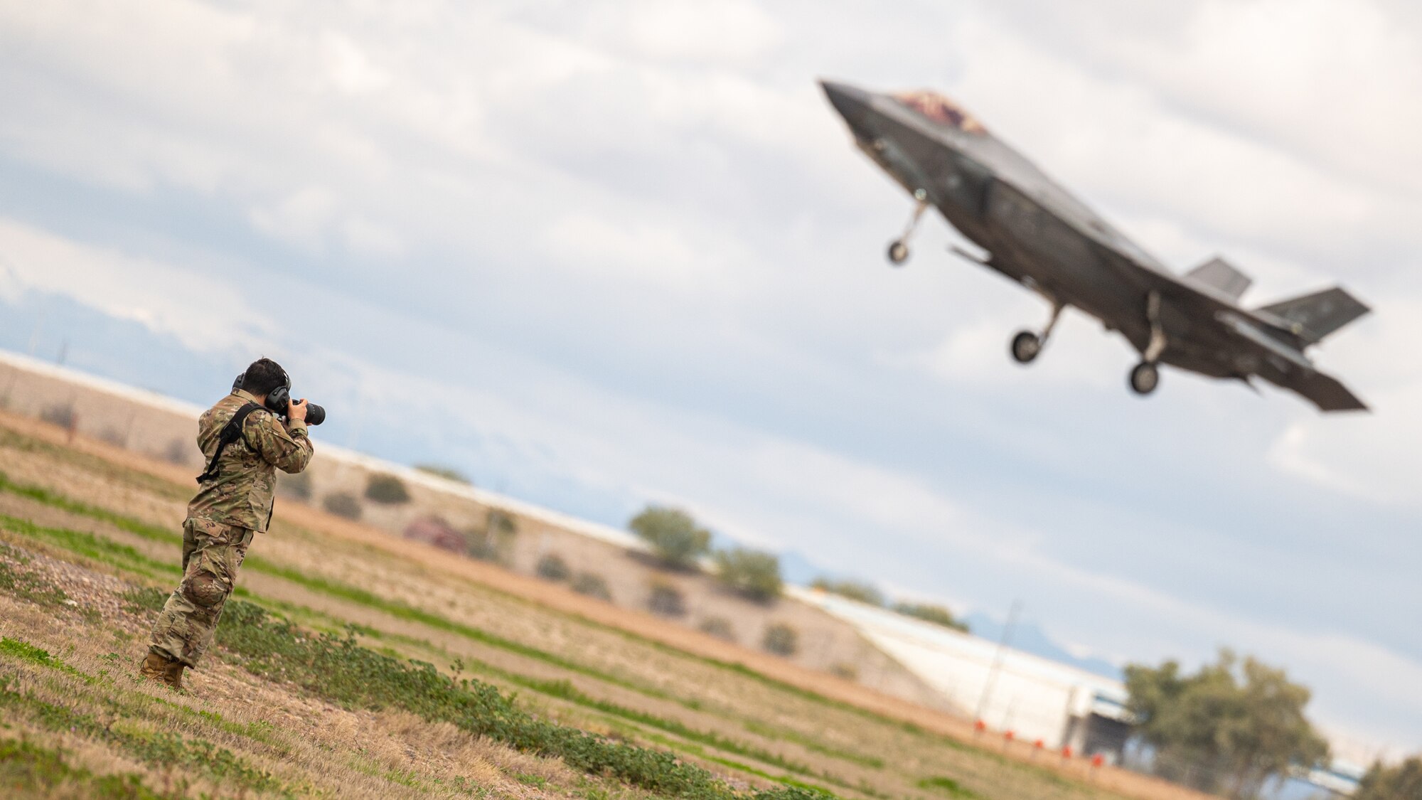 U.S. Air Force Airman 1st Class Elias Carrero takes a photo of an F-35 Lightning II assigned to the 56th Fighter Wing at Luke Air Force Base, Arizona, Mar. 3, 2023.
